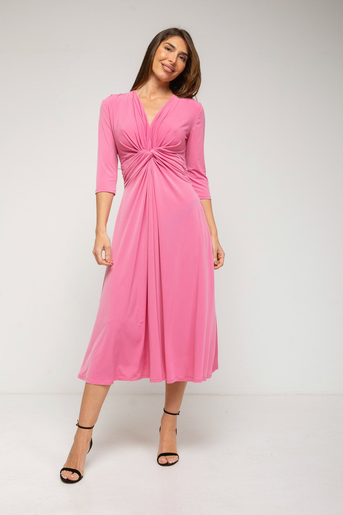 Woman wearing a pink dress on a white background