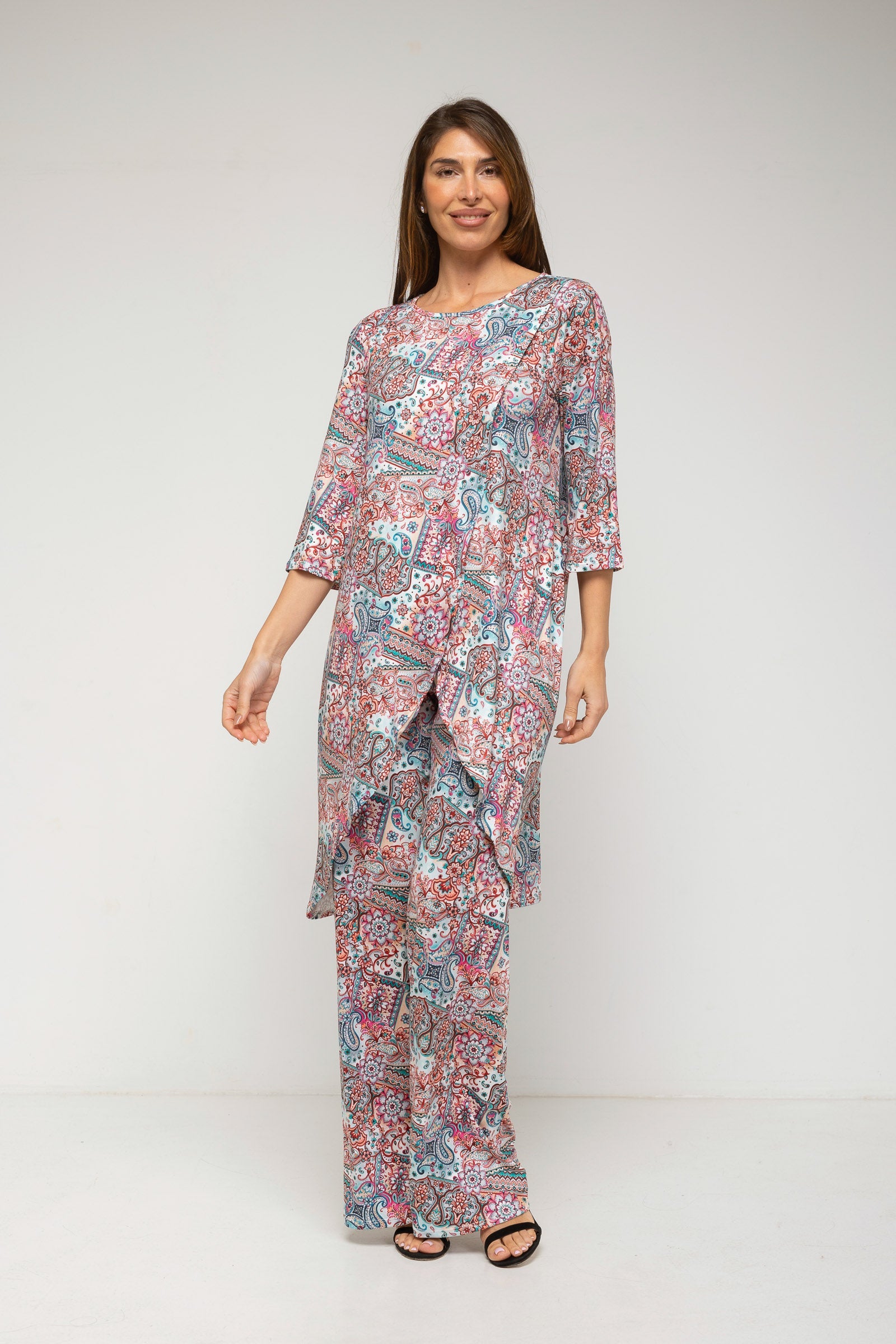 Woman wearing a patterned outfit on a white background