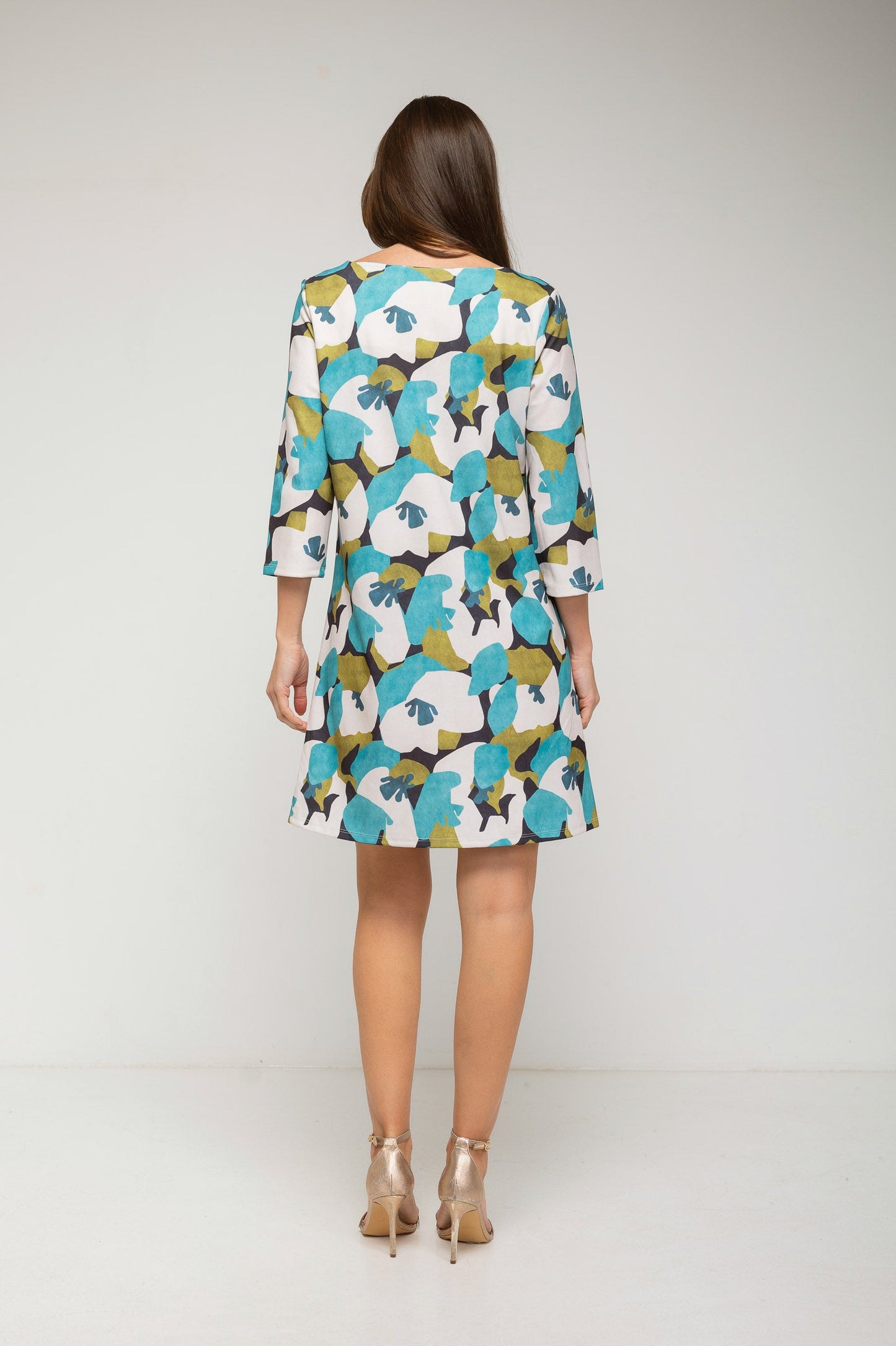 Woman wearing a floral dress with a white background