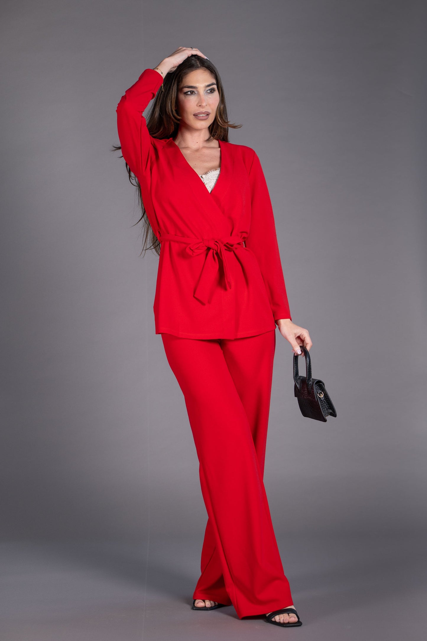 Woman wearing a red outfit against a gray background