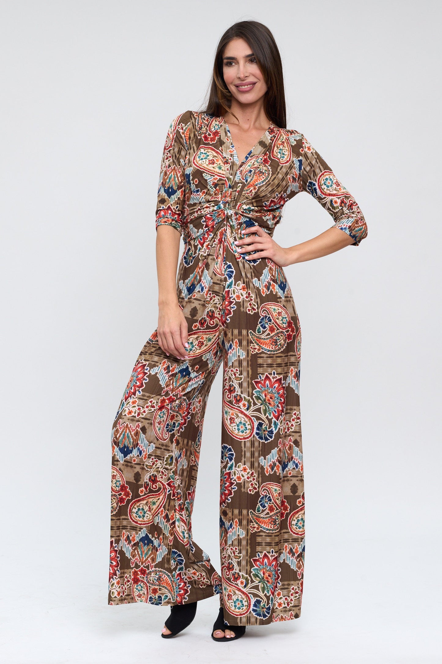 Woman wearing a patterned jumpsuit on a white background