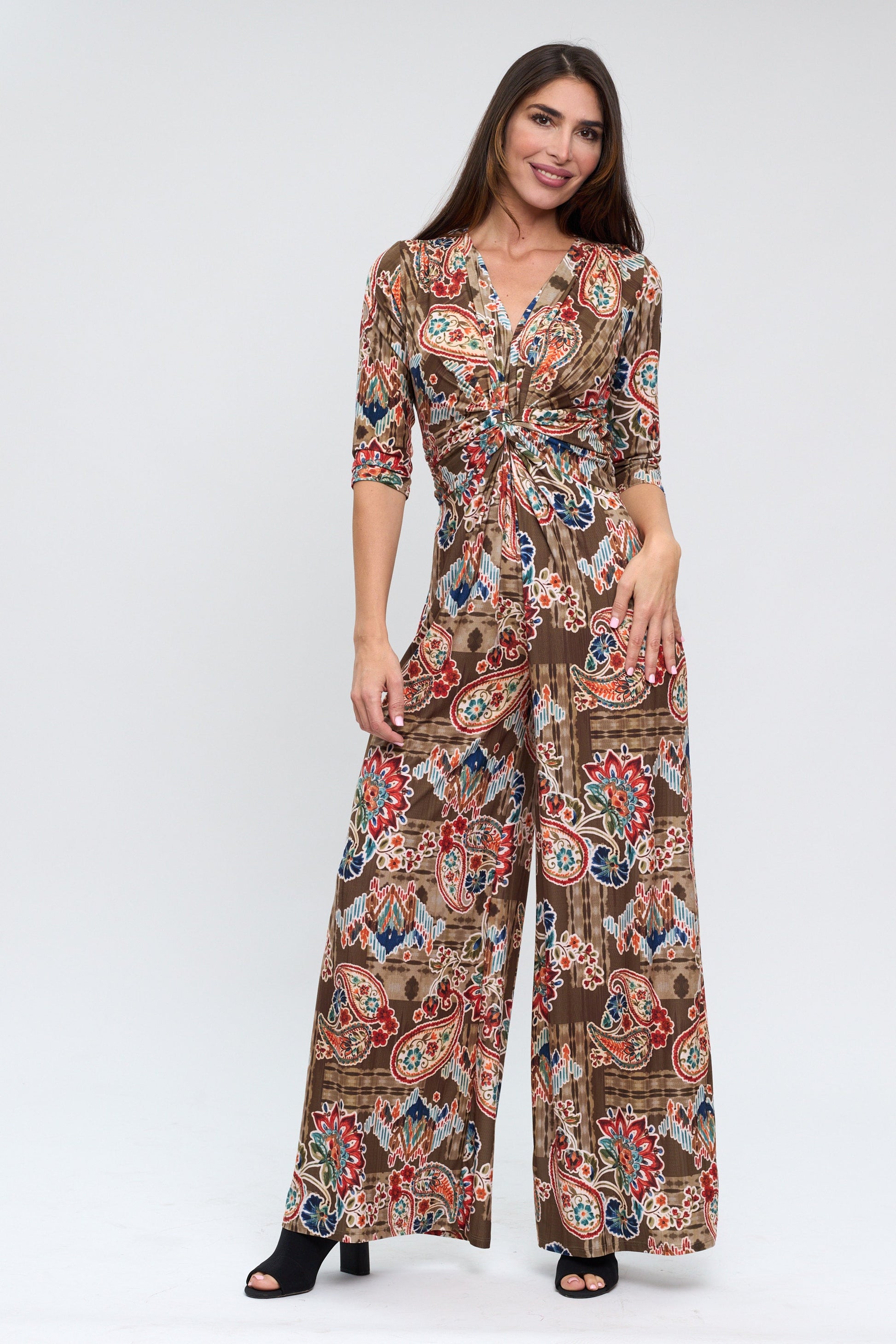 Woman wearing a patterned jumpsuit on a white background