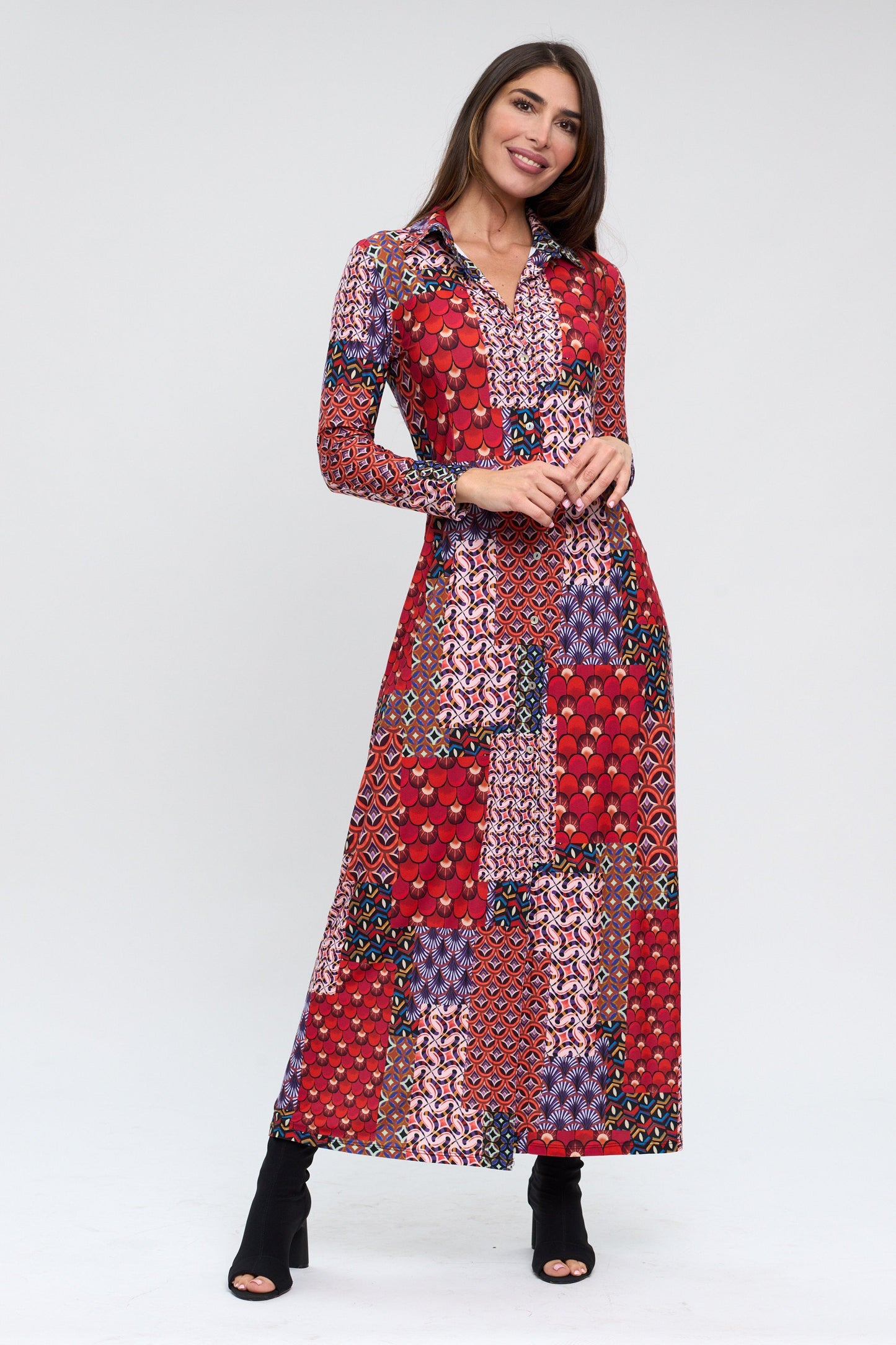 Woman wearing a long, patterned dress on a white background