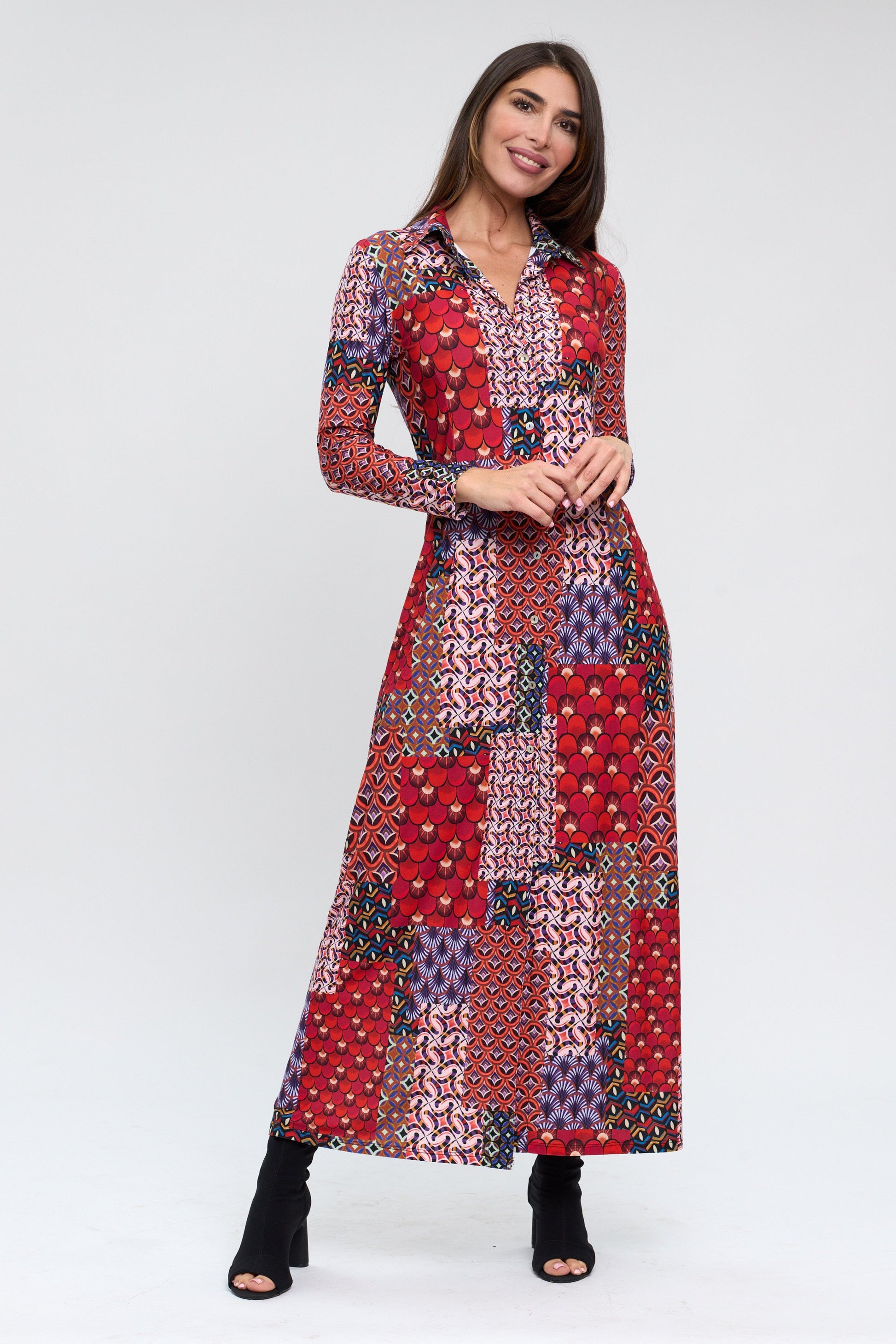 Woman wearing a long, patterned dress on a white background