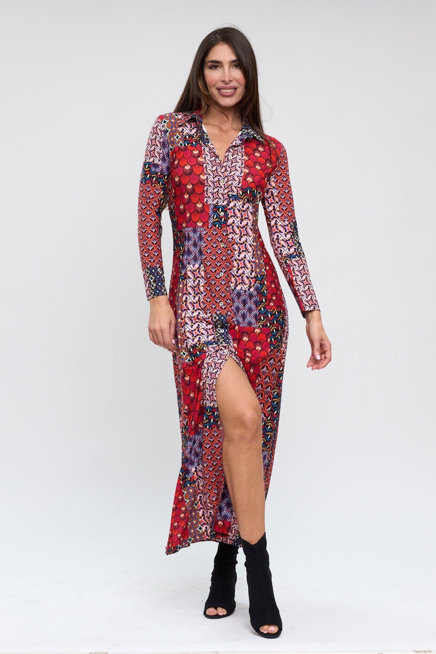 Woman wearing a colorful patterned dress on a white background