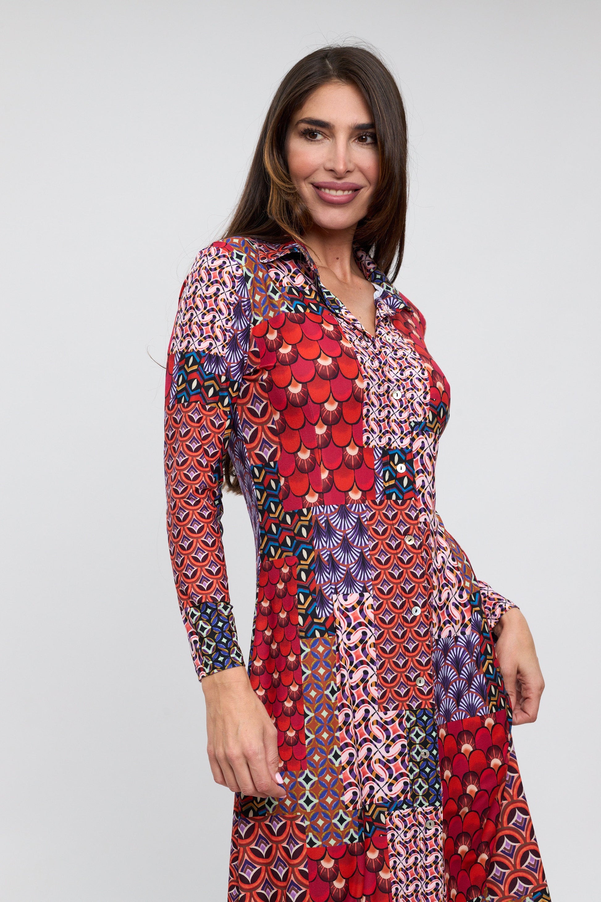 Woman wearing a colorful patterned dress on a white background