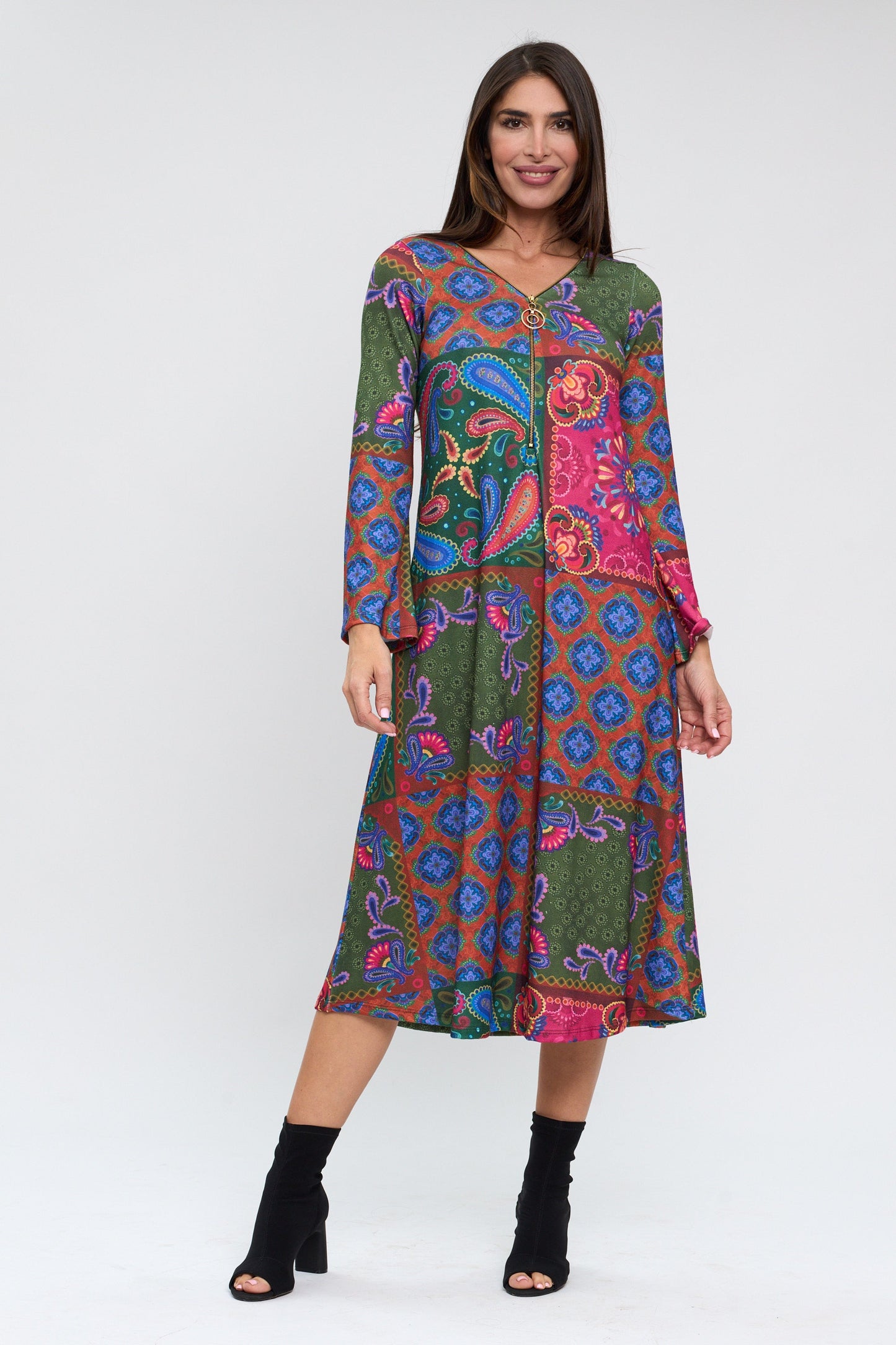 Woman wearing a colorful patterned dress on a white background