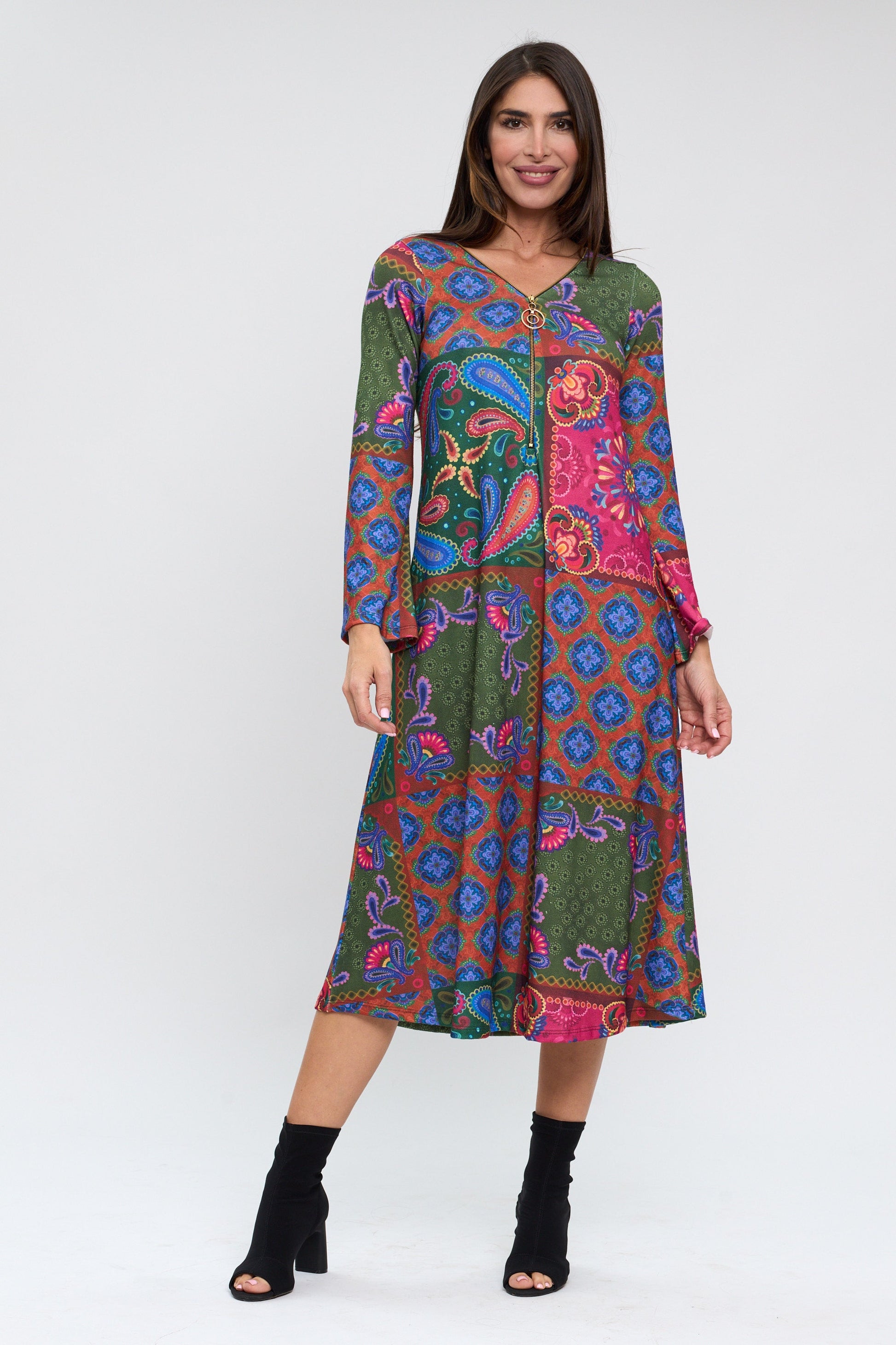 Woman wearing a colorful patterned dress on a white background