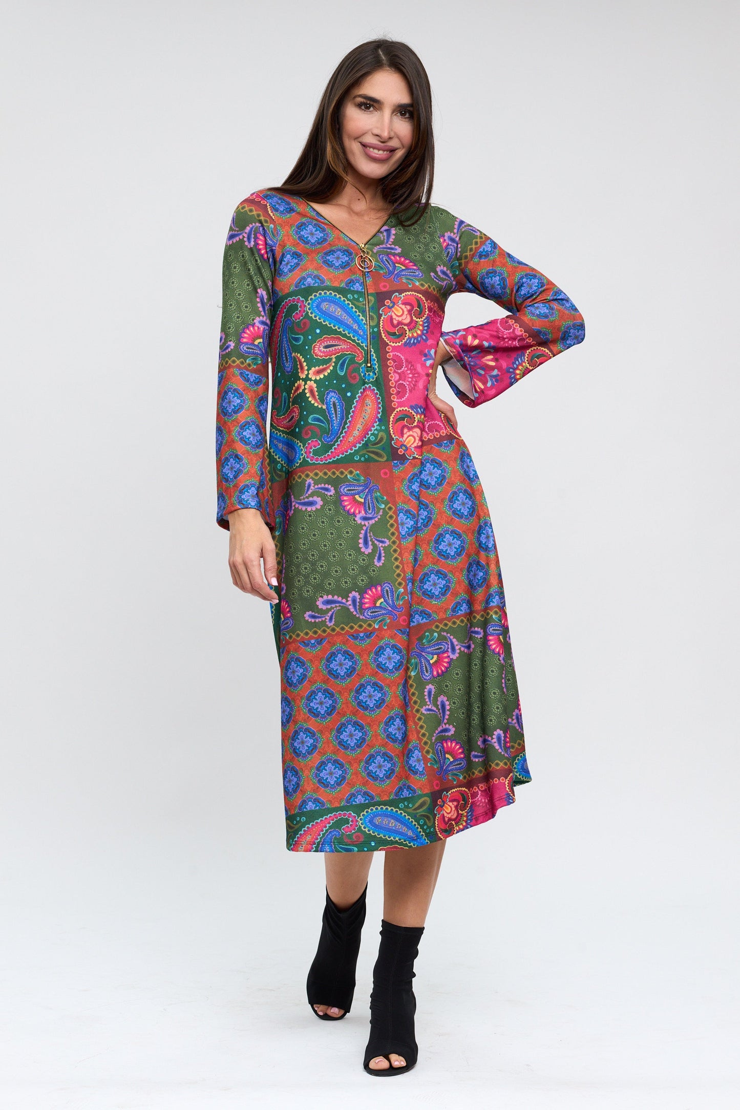 Woman wearing a colorful patterned dress on a white background
