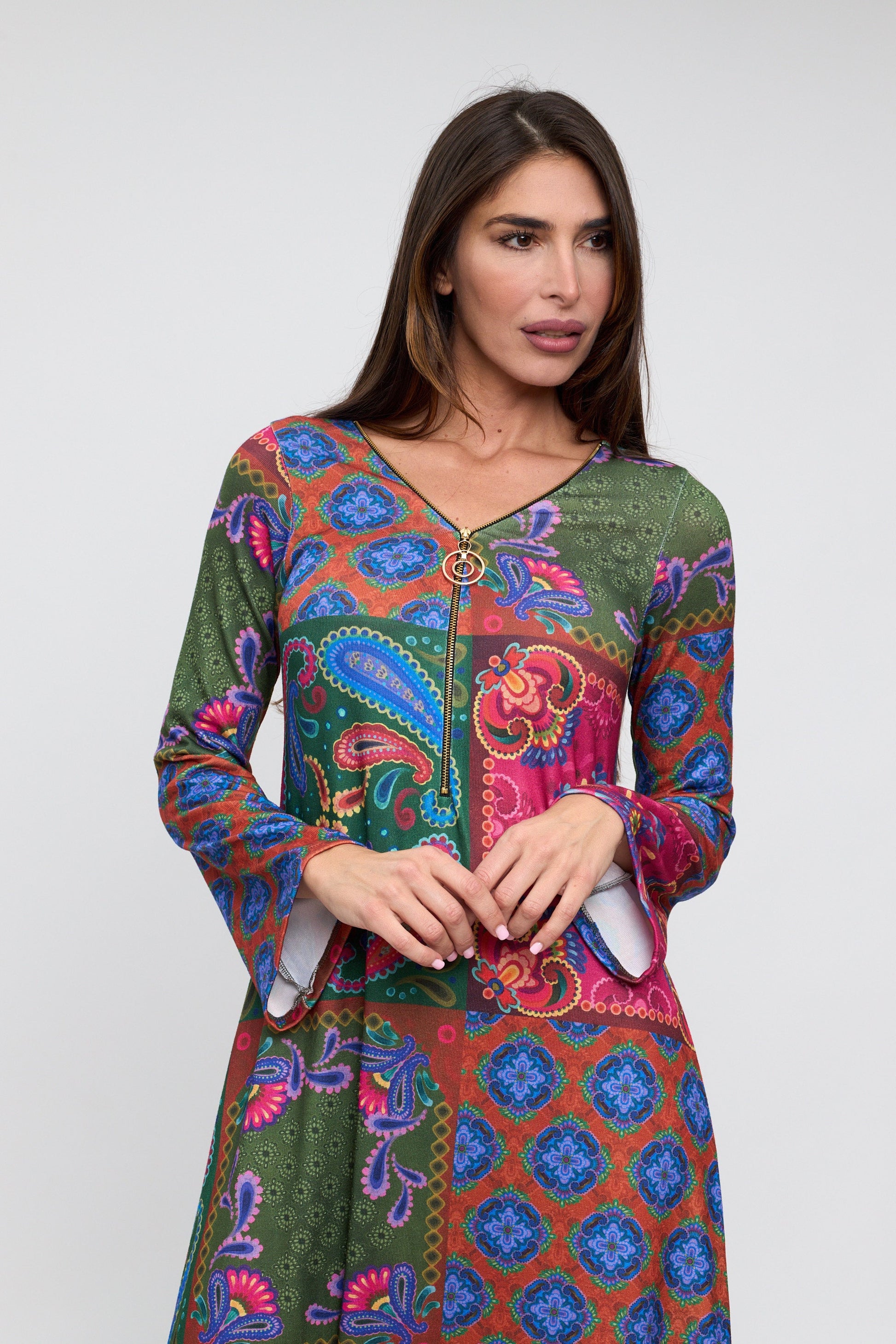 Woman wearing a colorful patterned dress on a white background