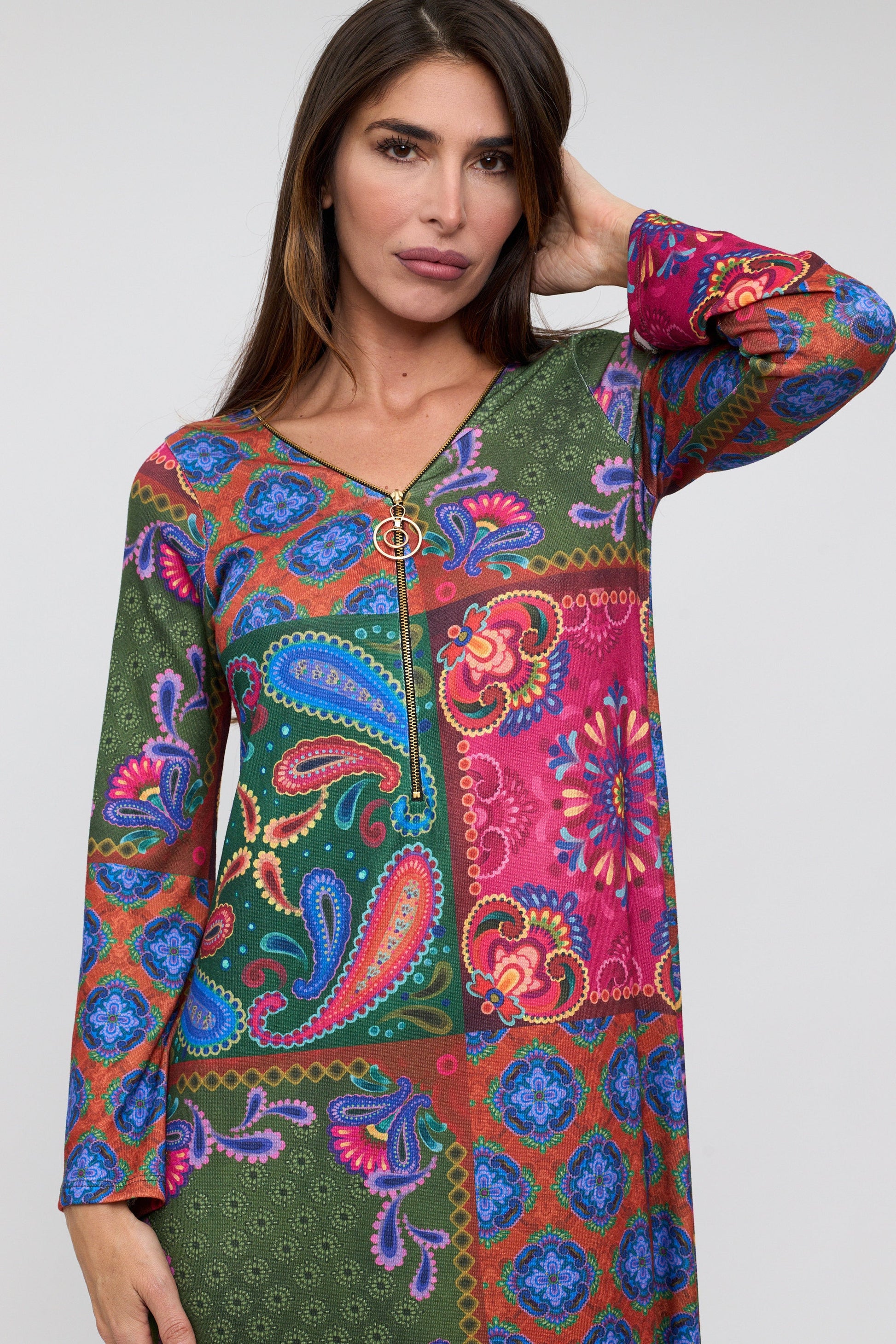 Woman wearing a colorful patterned dress on a white background