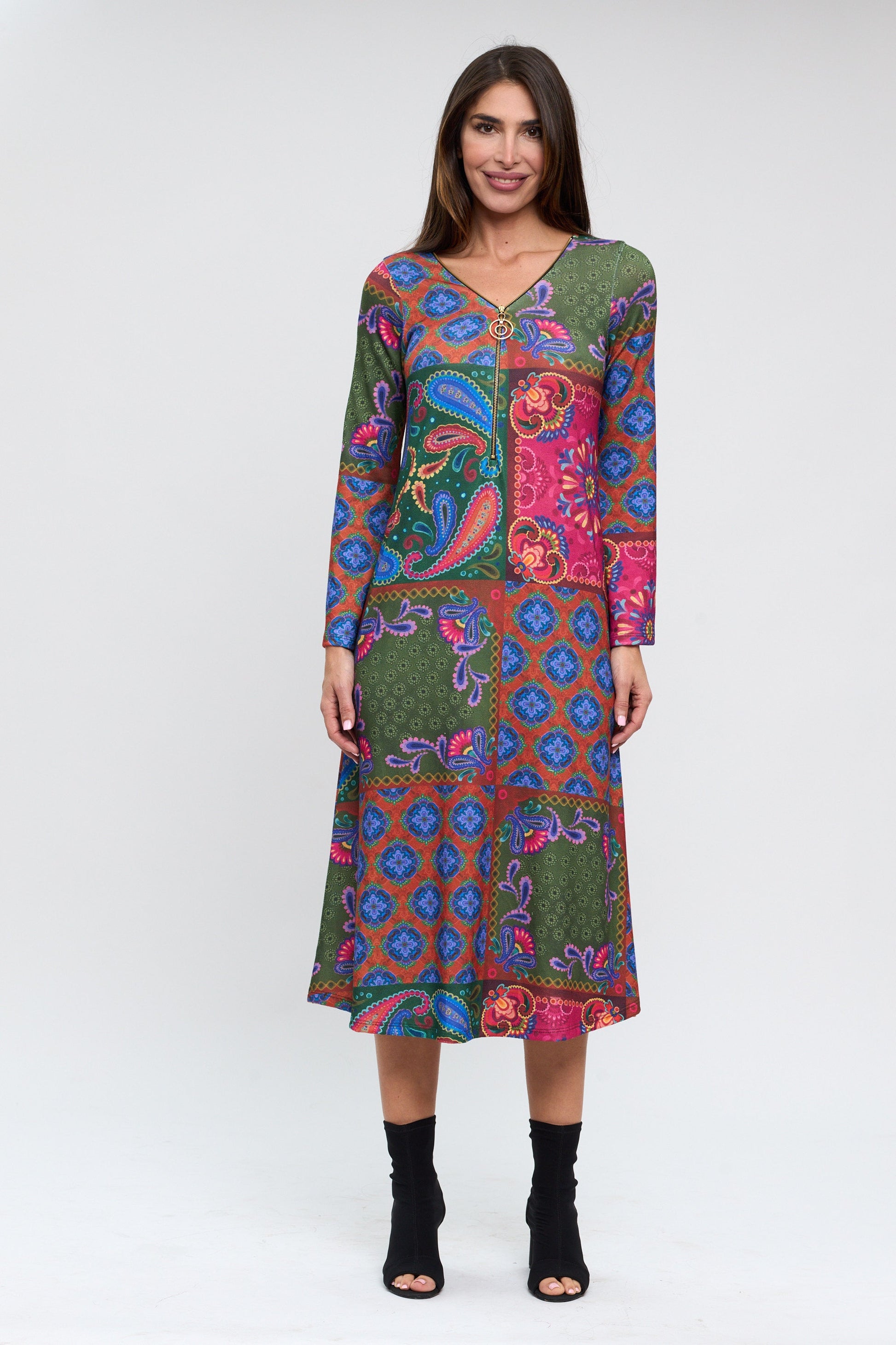 Woman wearing a colorful patterned dress on a white background