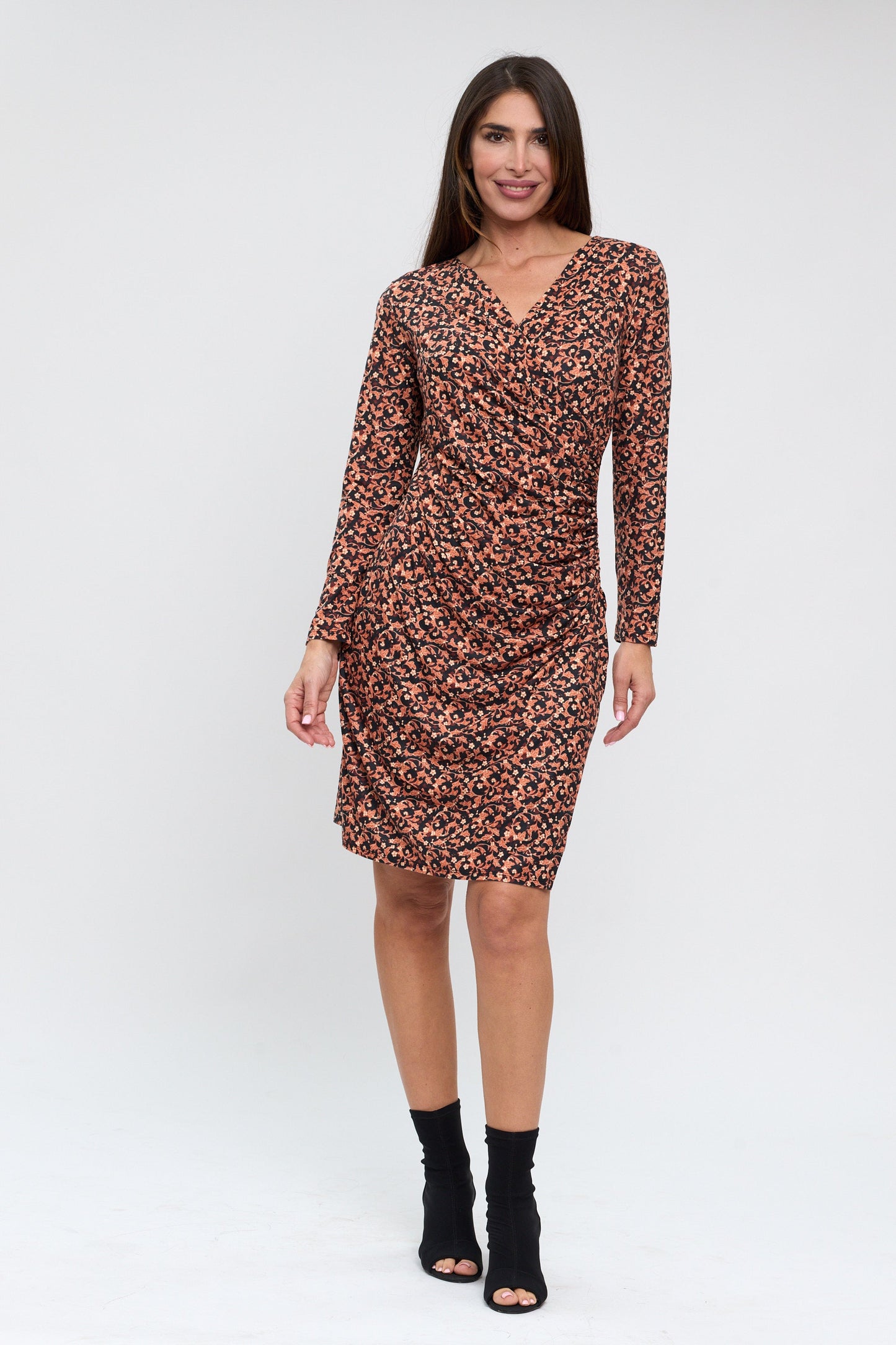 Woman wearing a patterned dress on a white background