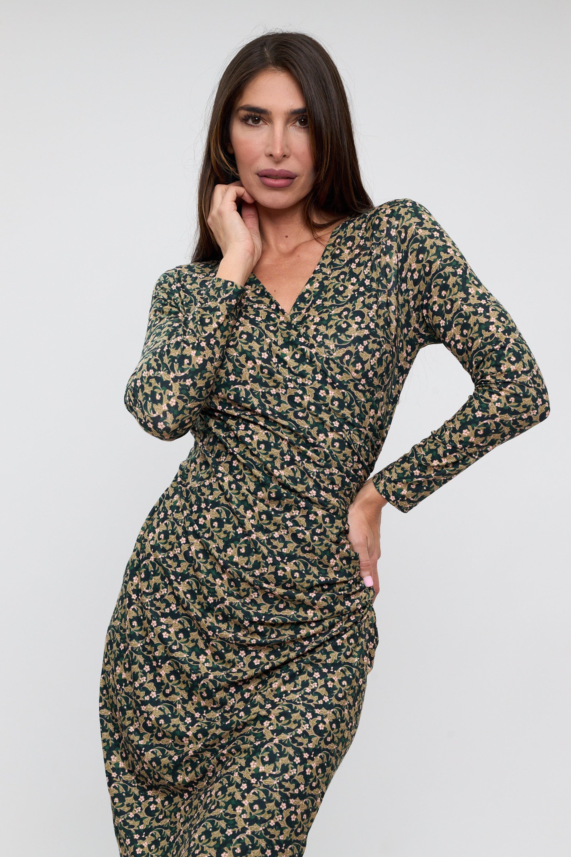 Woman wearing a floral dress against a white background