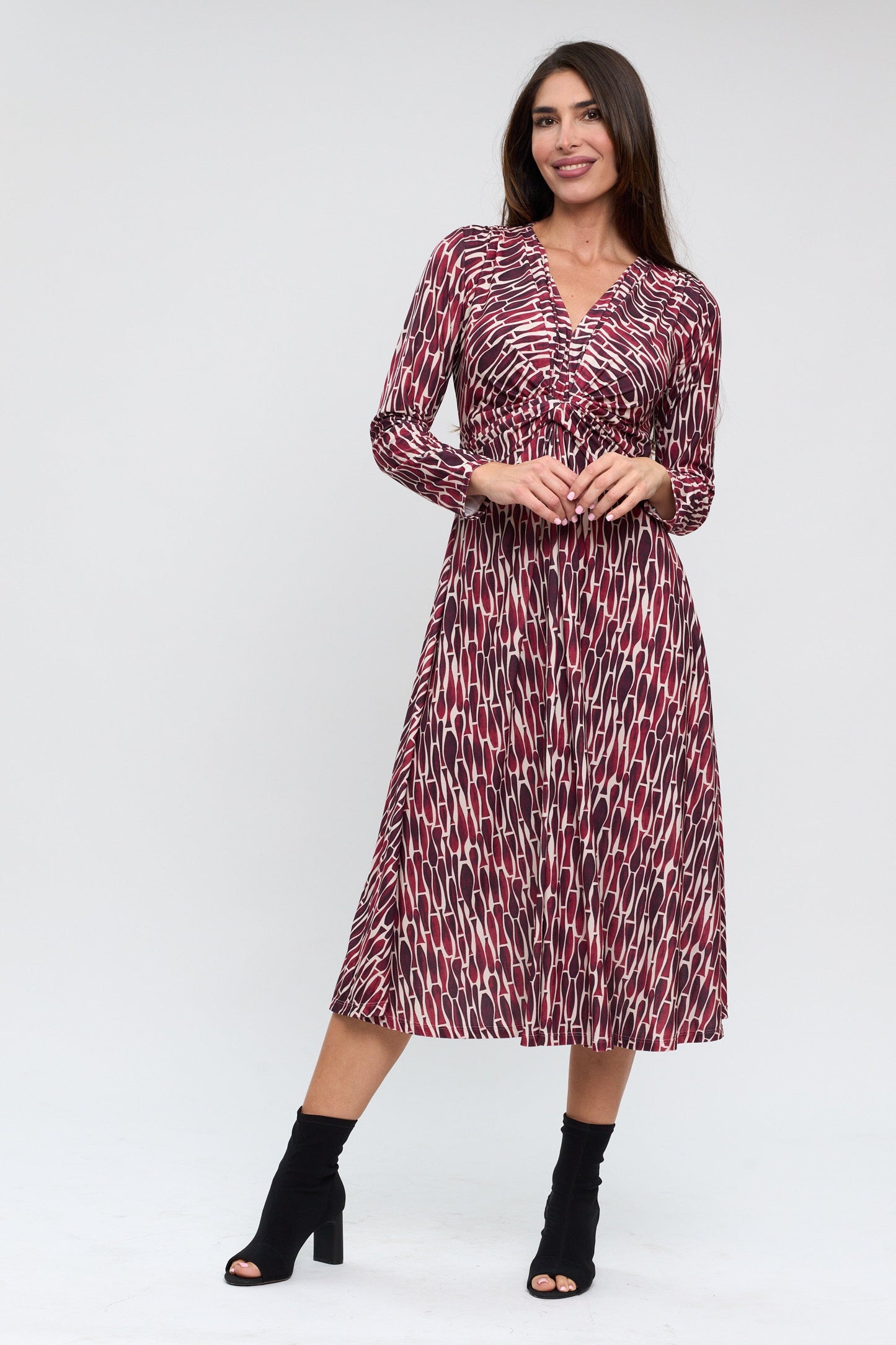 Woman wearing a patterned dress on a white background