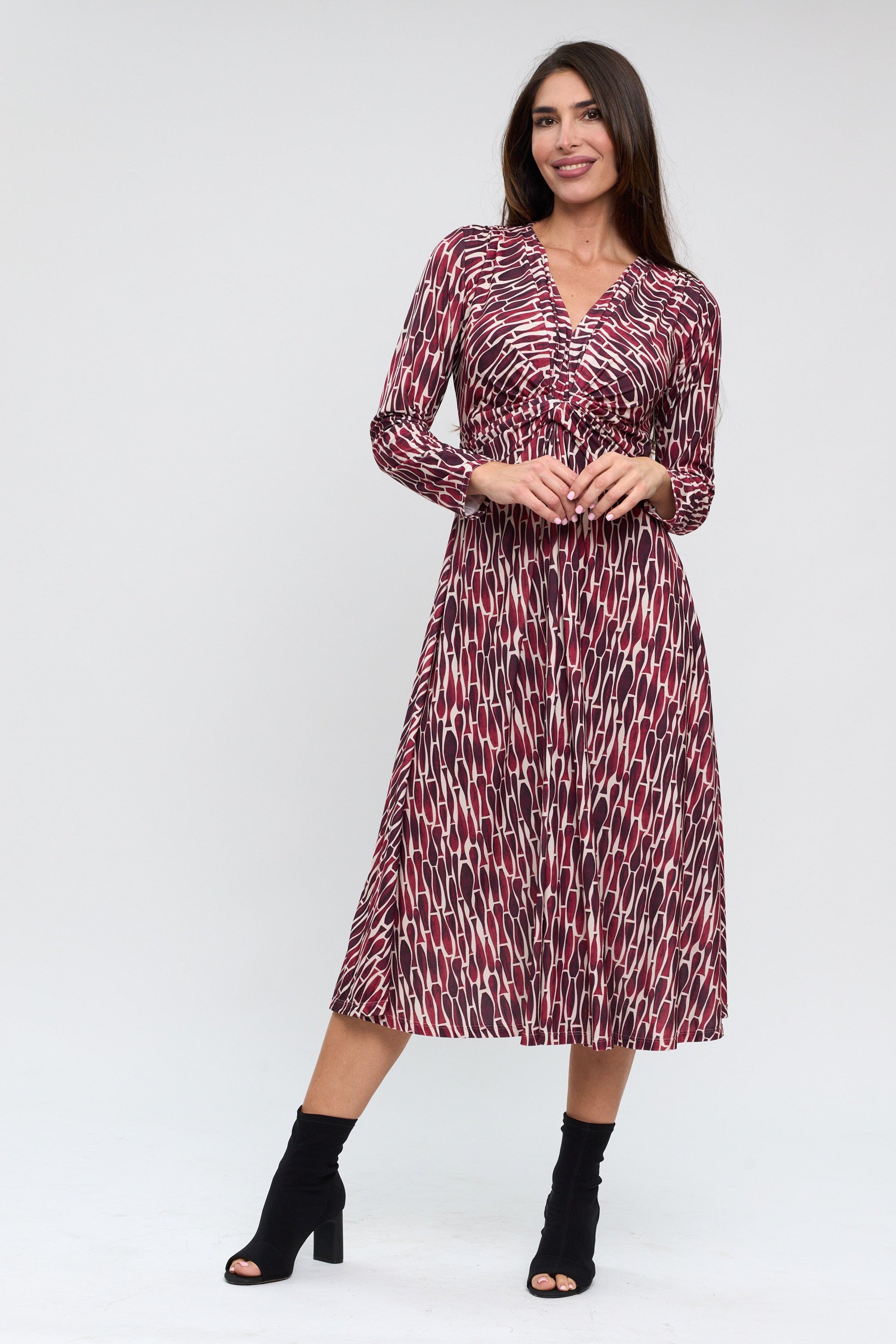 Woman wearing a patterned dress on a white background