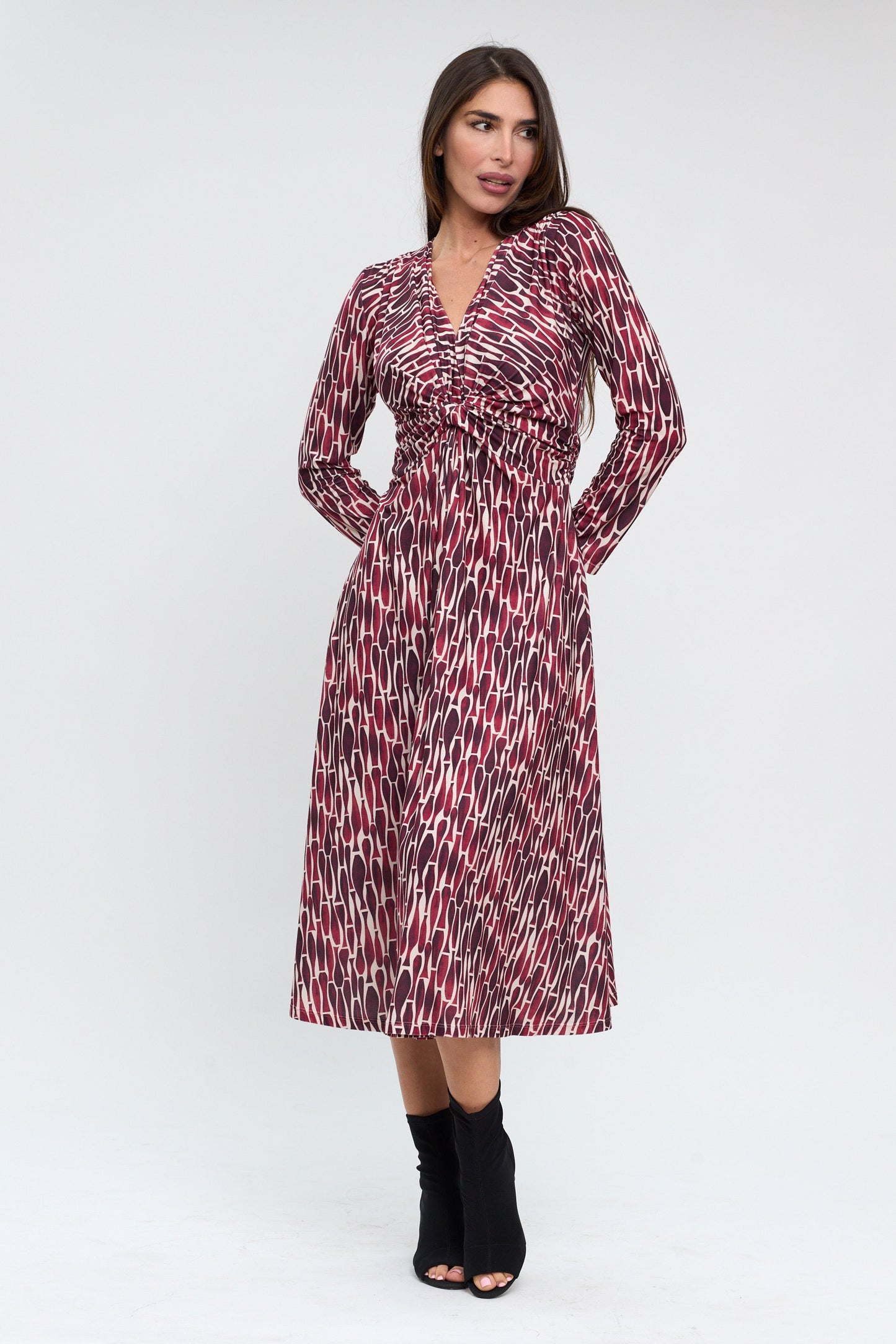 Woman wearing a patterned dress on a white background