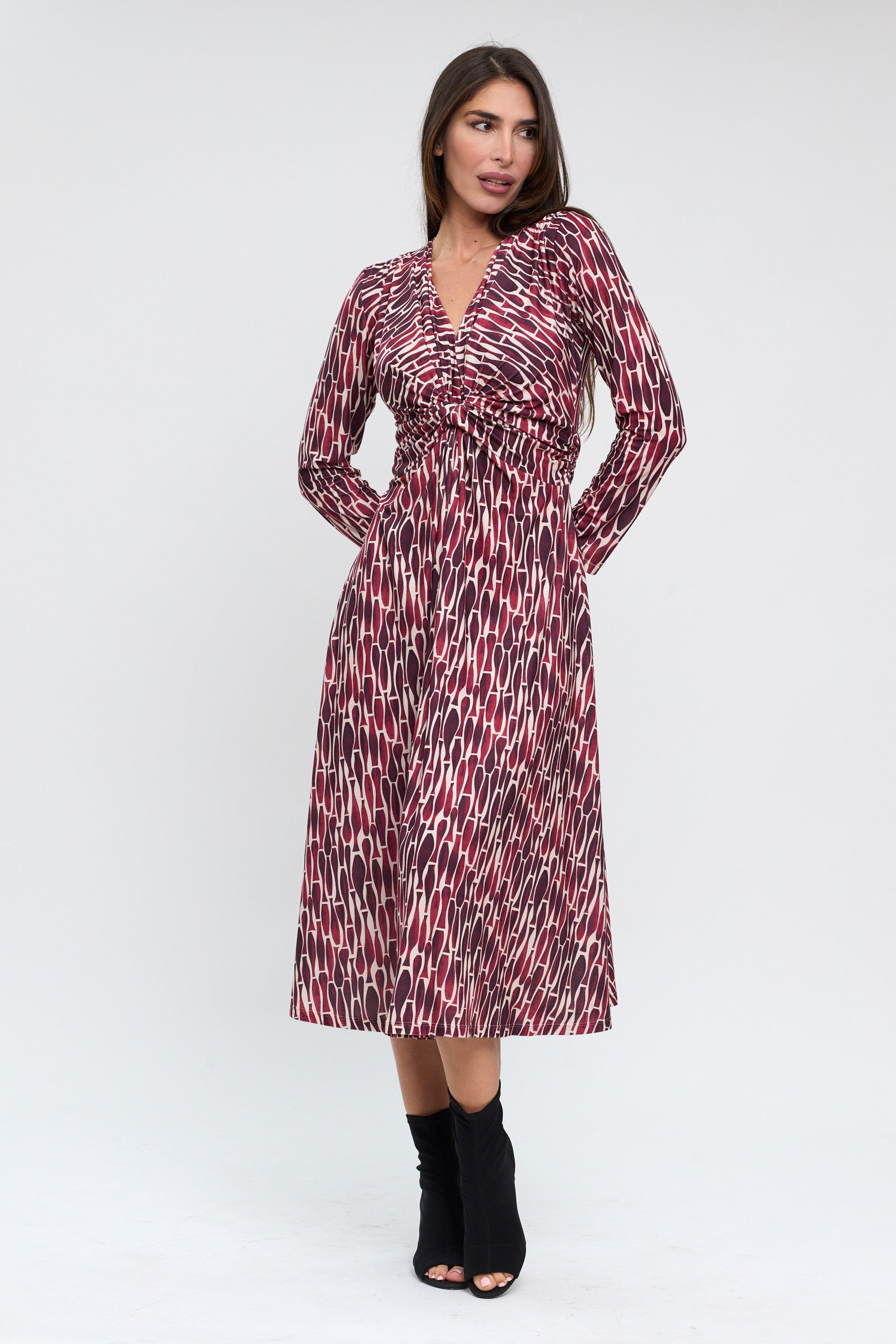 Woman wearing a patterned dress on a white background