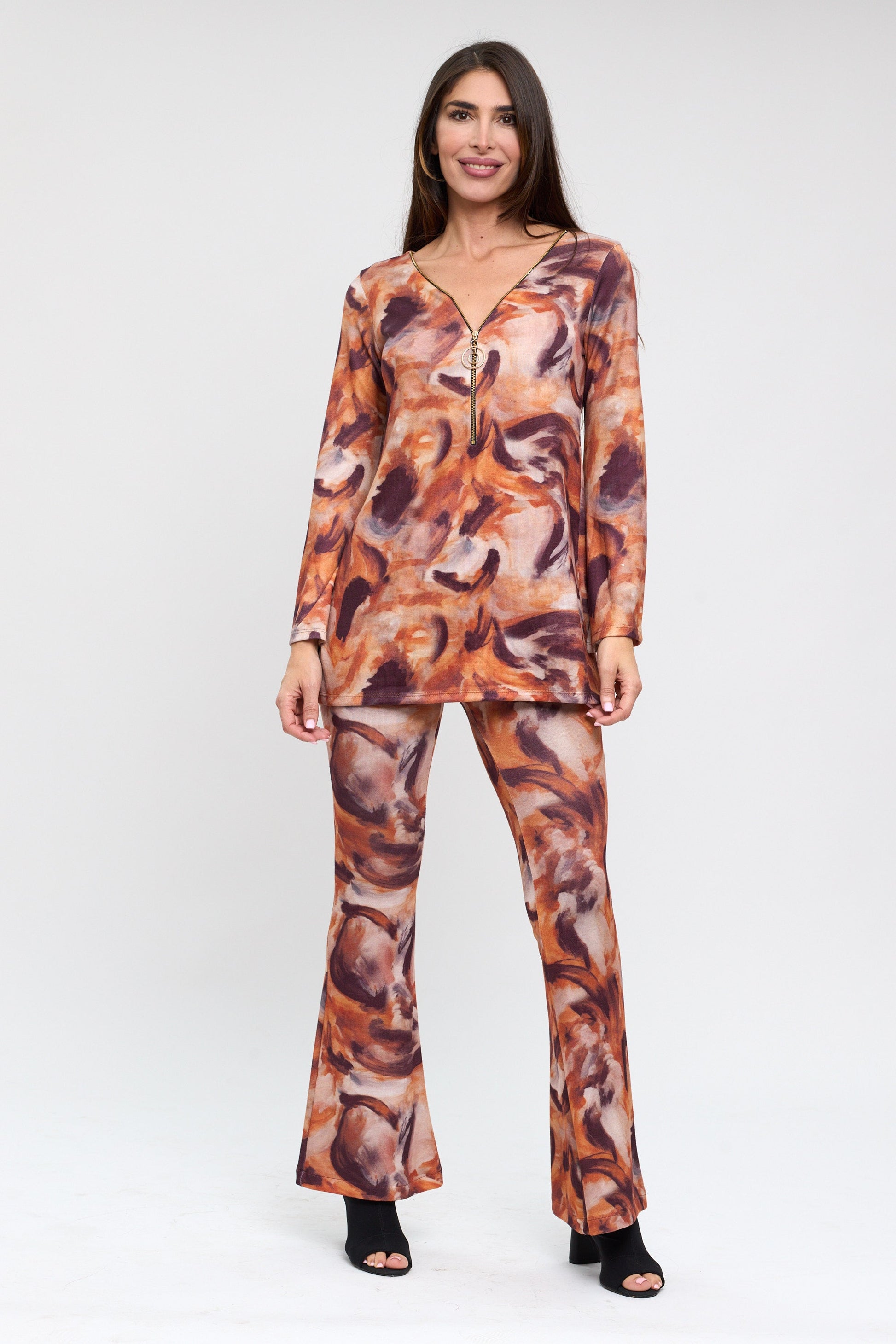 Woman wearing a patterned outfit on a white background