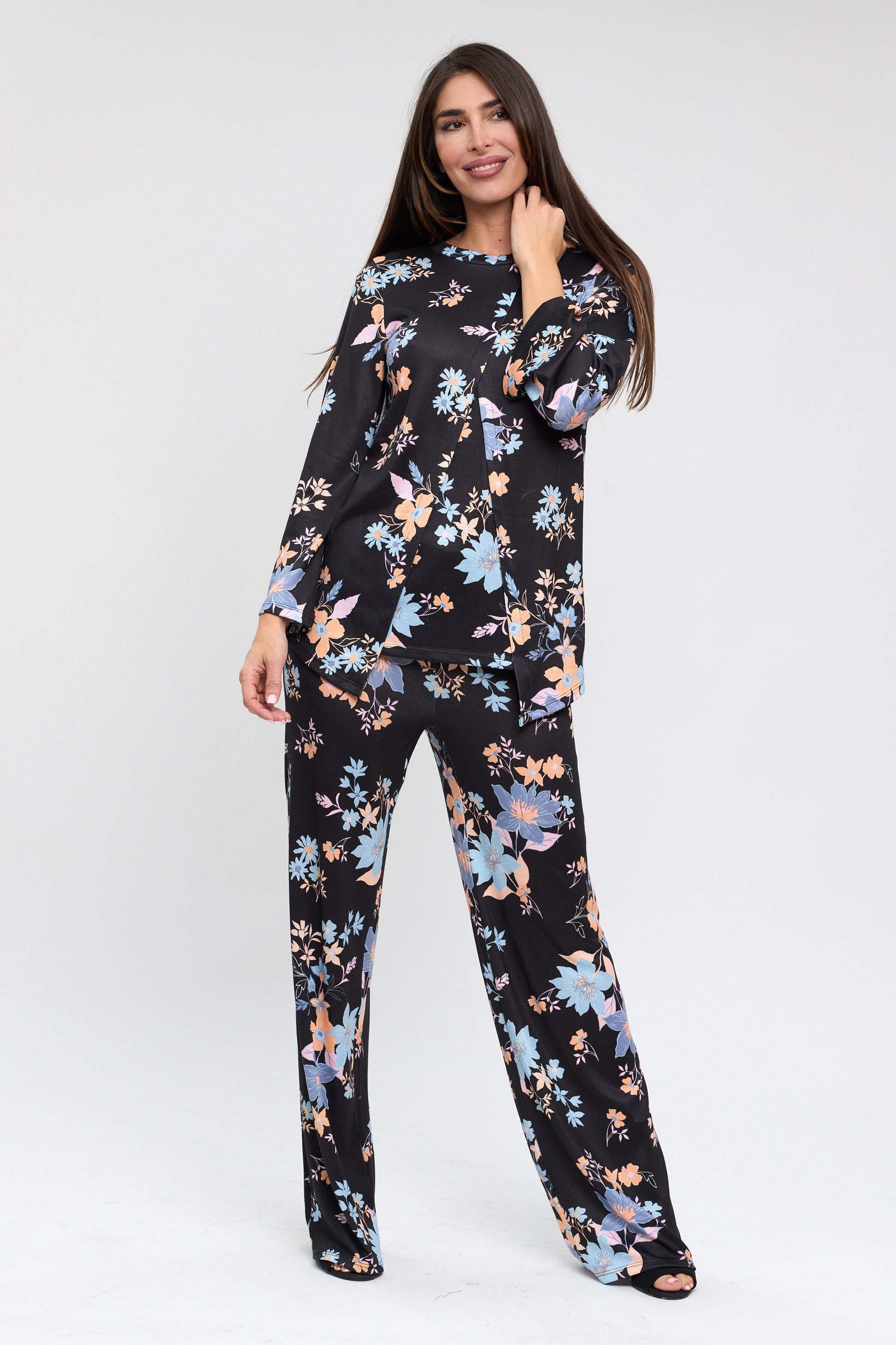 Woman wearing a floral pajama set on a white background