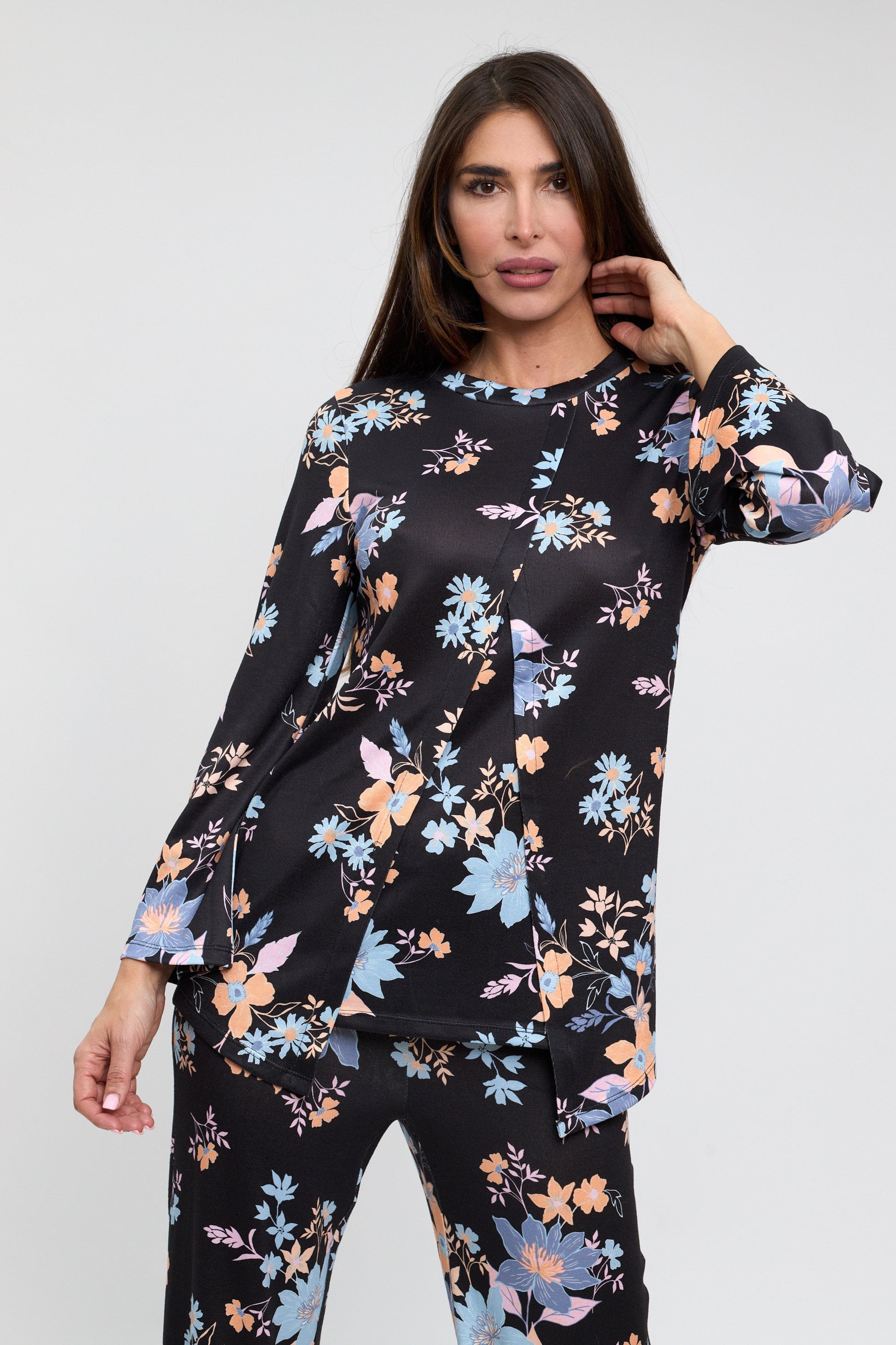 Woman wearing a black floral outfit on a white background