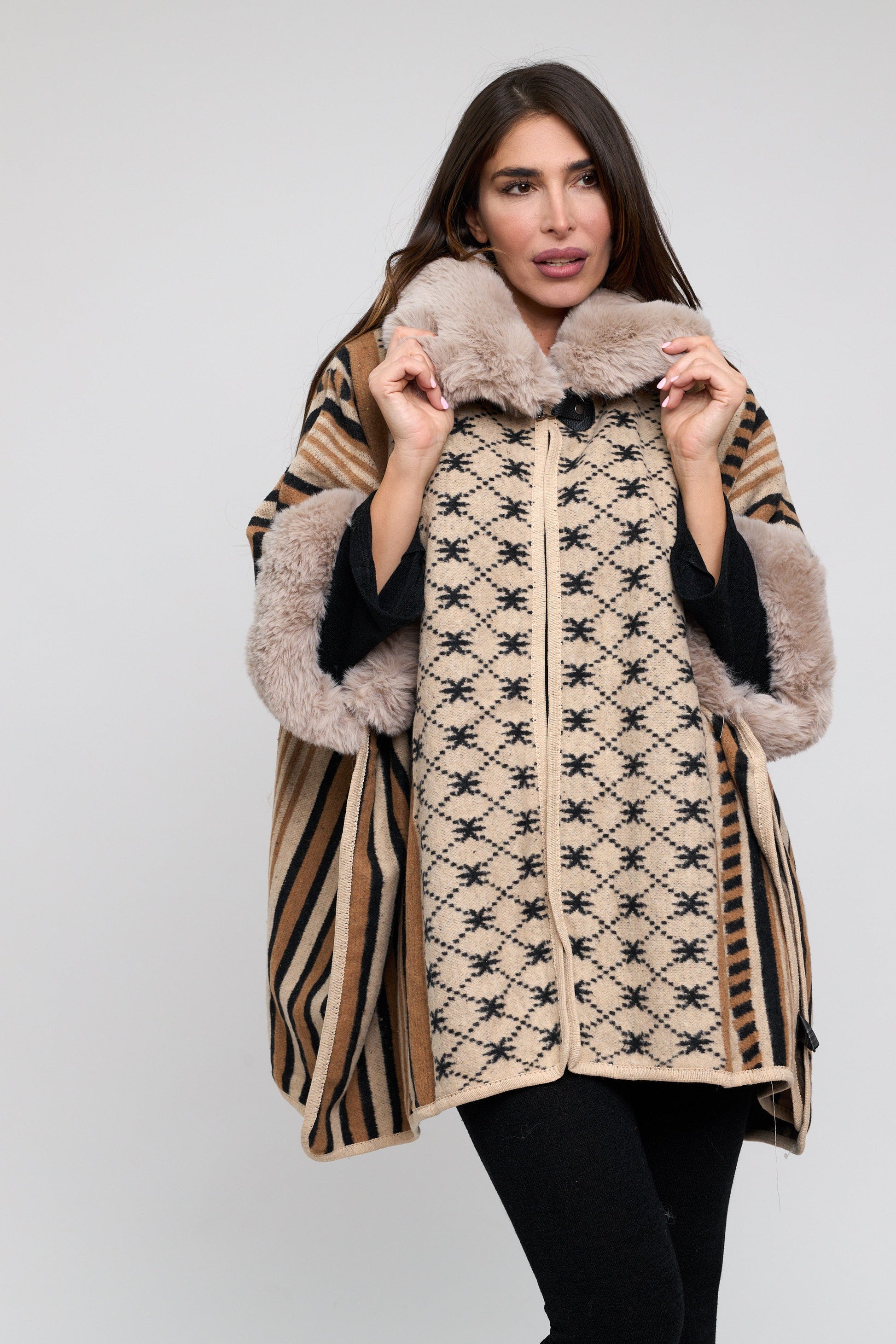 Woman wearing a patterned coat with fur trim on a white background