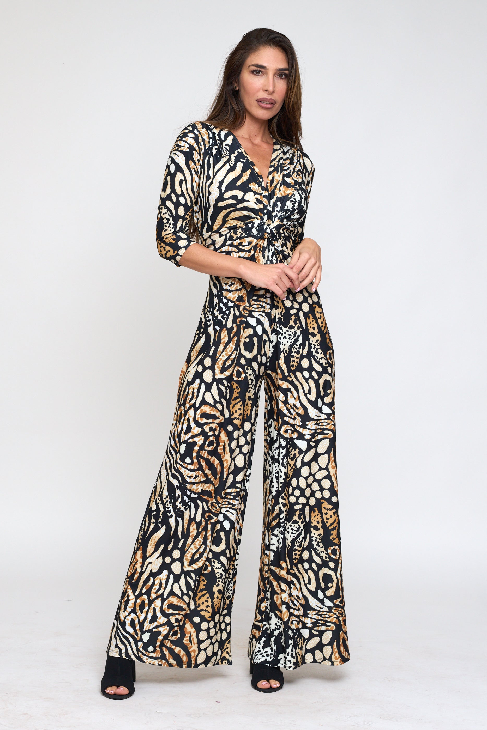 Woman wearing a patterned jumpsuit on a white background