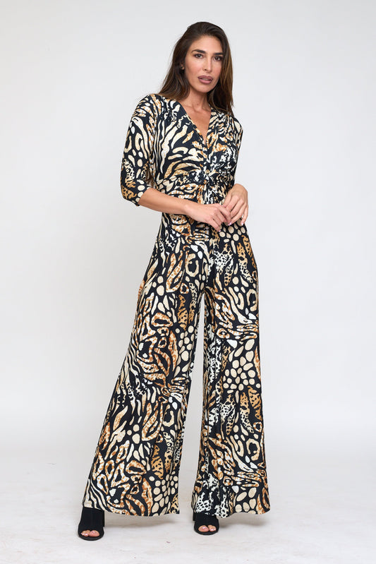 Woman wearing a patterned jumpsuit on a white background