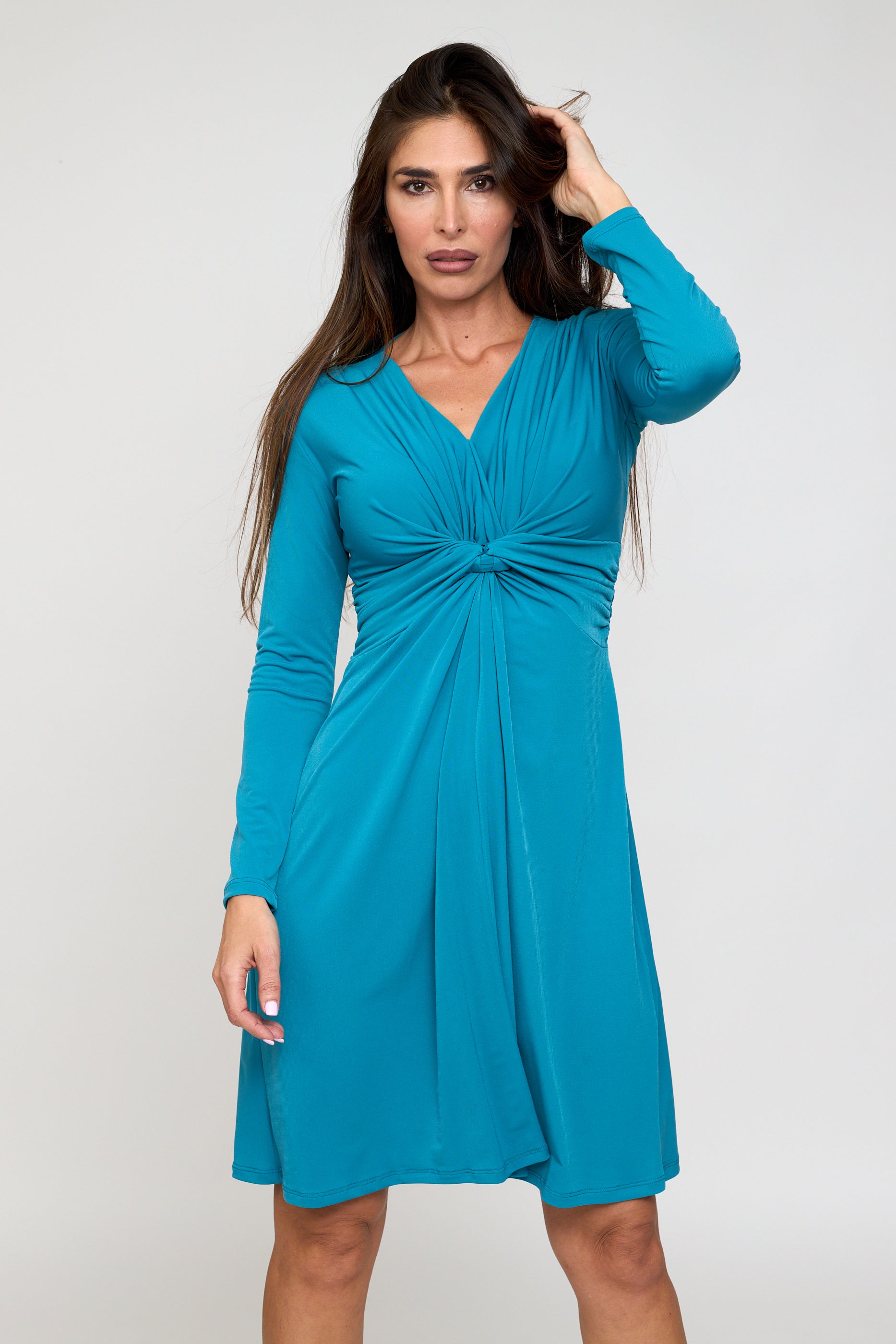 Woman wearing a blue dress against a white background