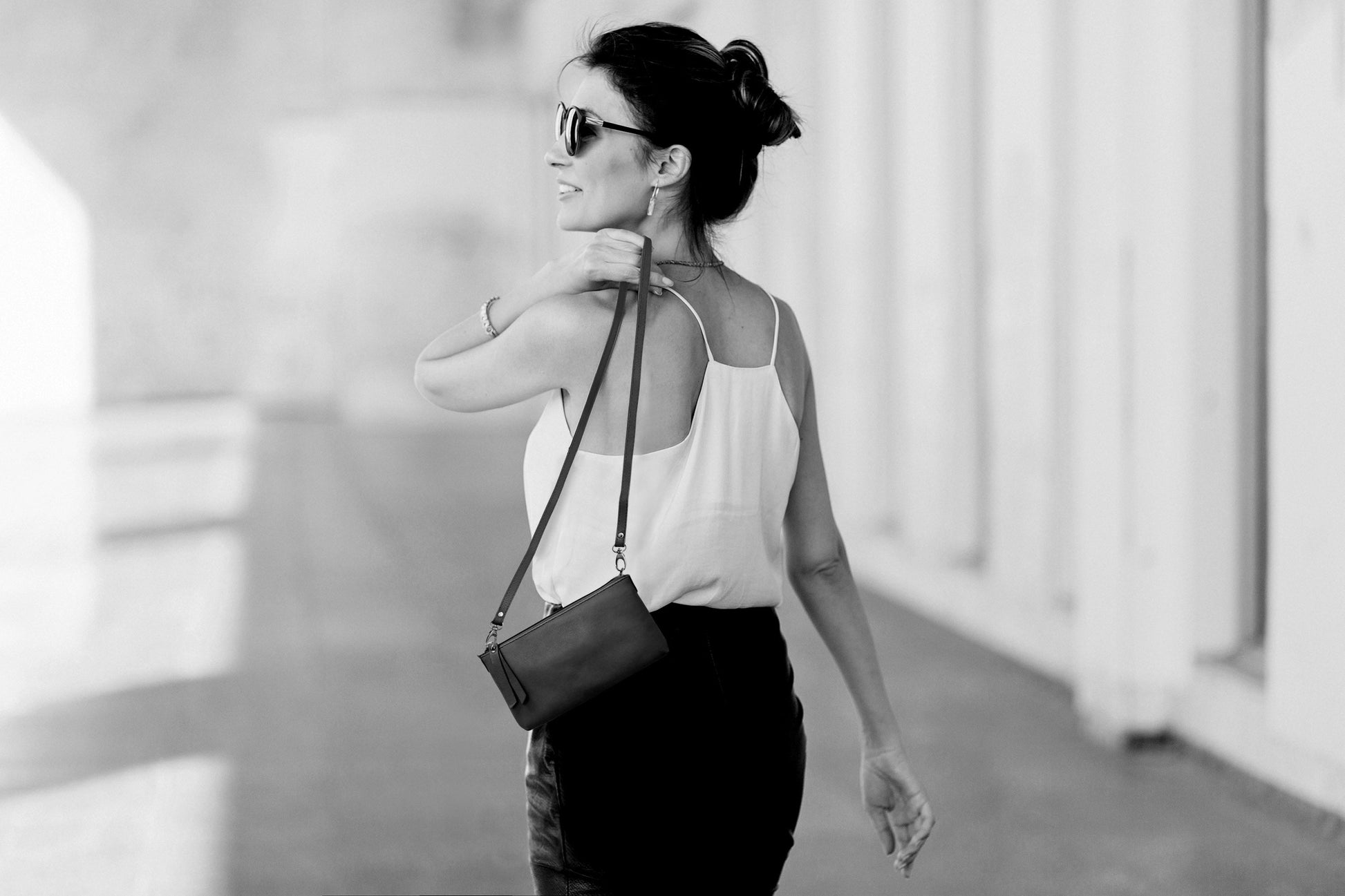 Woman walking with a handbag in a blurred indoor setting