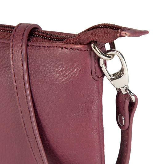 Close-up of a maroon leather handbag with a silver clasp on a white background