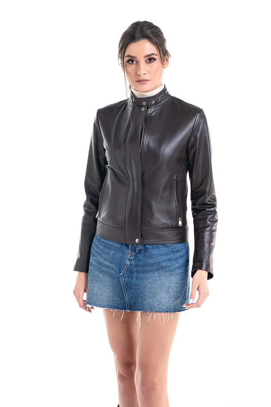 Woman wearing a brown leather jacket and blue denim skirt on a white background