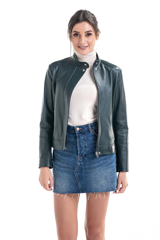 Woman wearing a green leather jacket, white turtleneck, and blue denim skirt on a white background