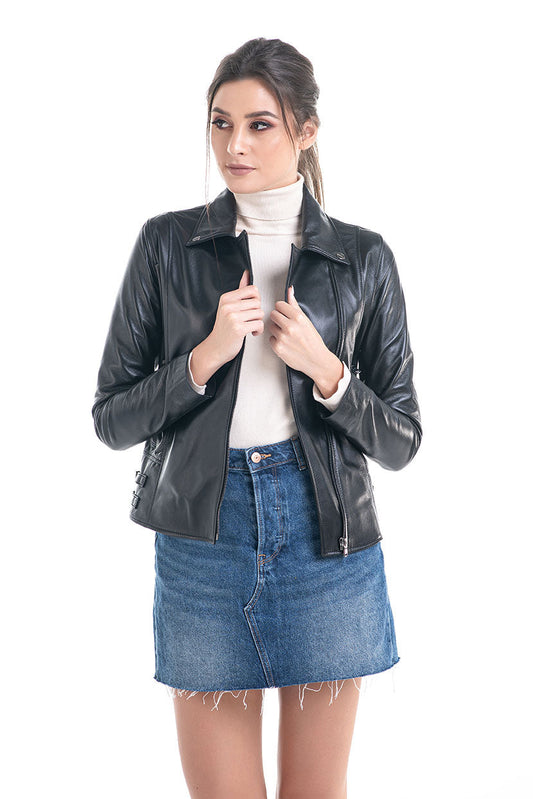 Woman wearing a black leather jacket and blue denim skirt on a white background