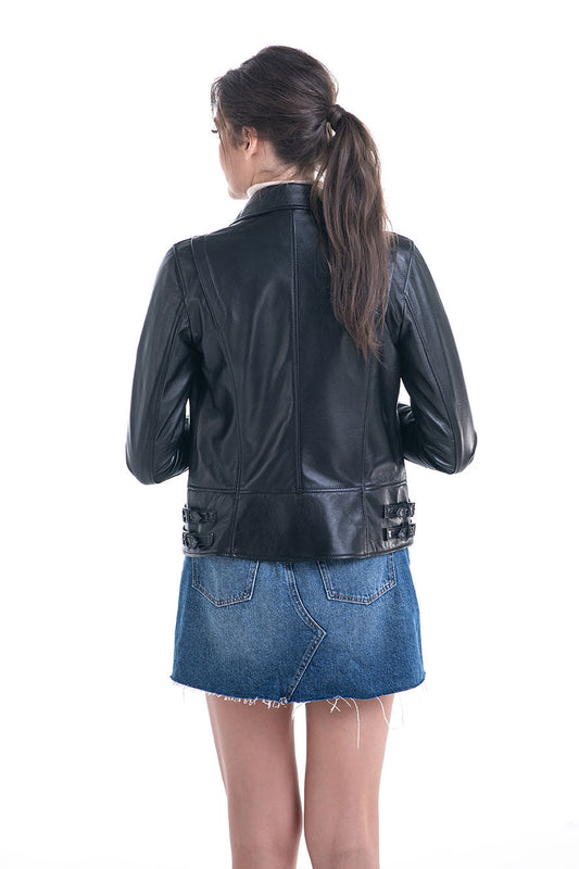 Person wearing a black leather jacket and blue denim skirt on a white background