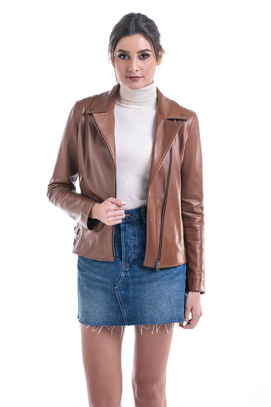 Woman wearing a brown leather jacket, white turtleneck, and blue denim skirt on a white background