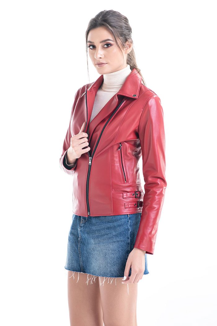 Woman wearing a red leather jacket and denim skirt on a white background