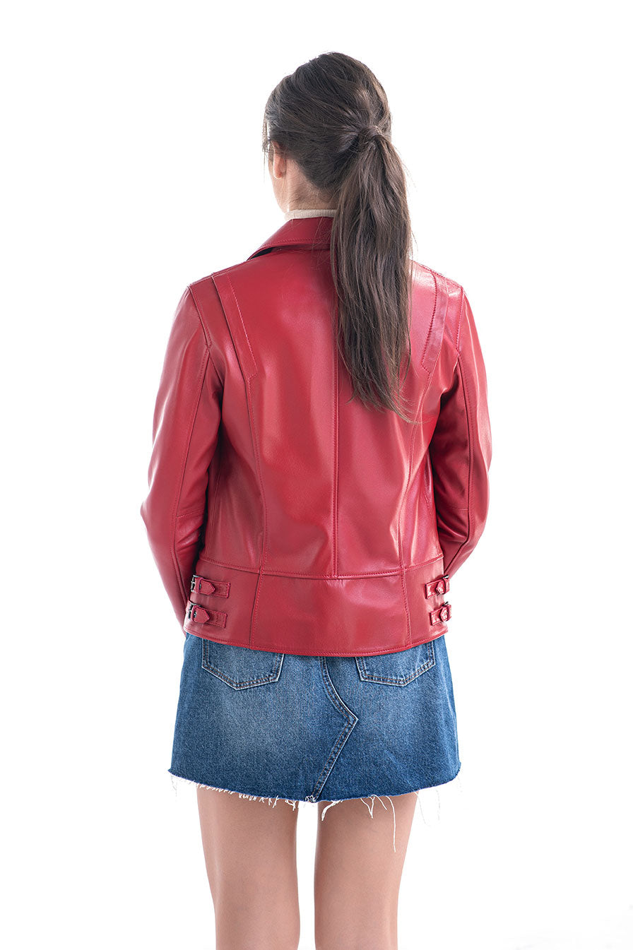 Person wearing a red leather jacket and blue denim skirt on a white background