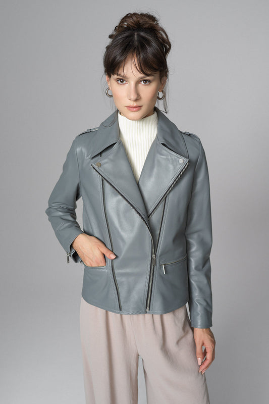 Woman wearing a gray leather jacket against a gray background