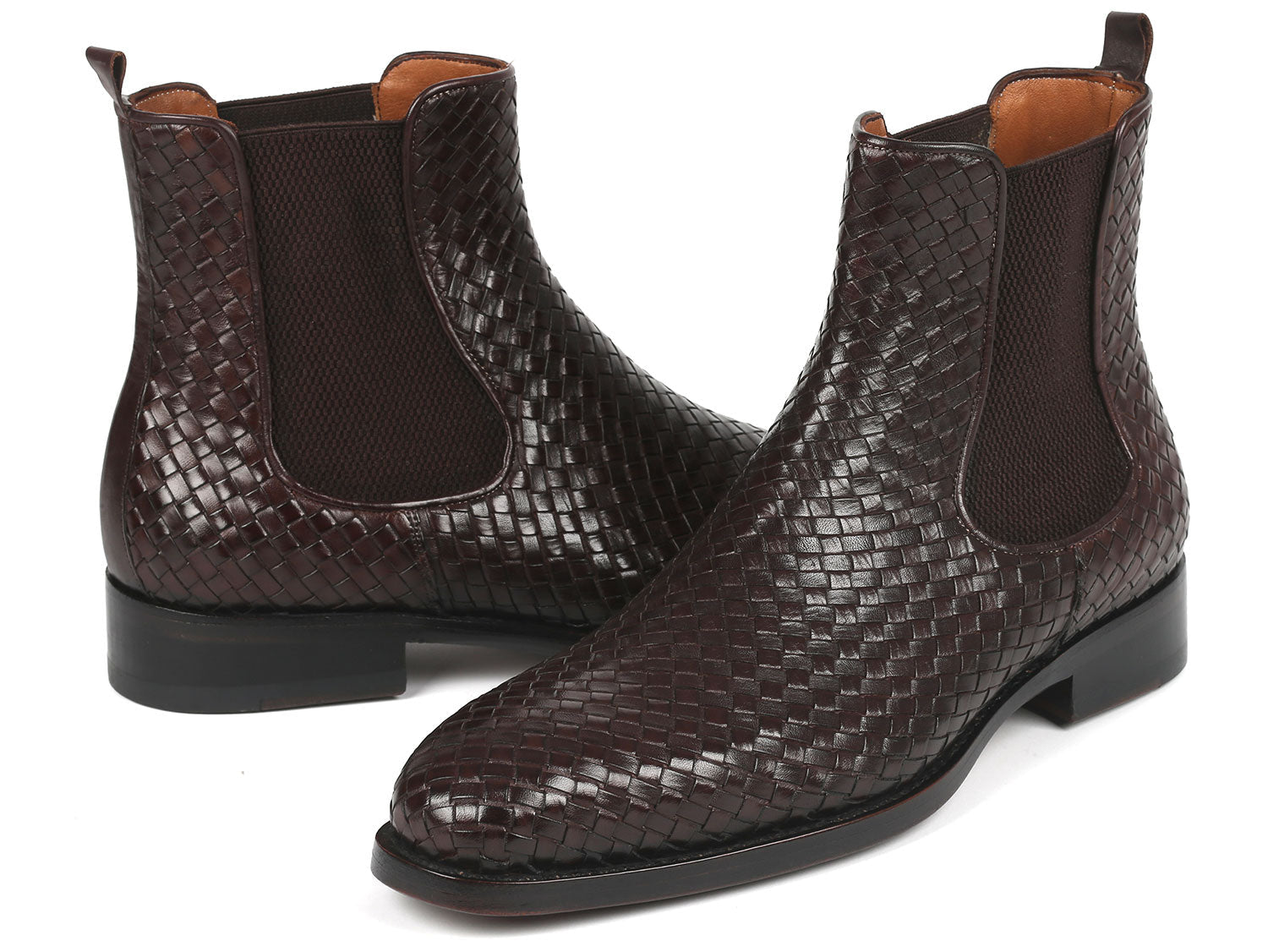 Pair of brown leather Chelsea boots with snake skin pattern on a white background
