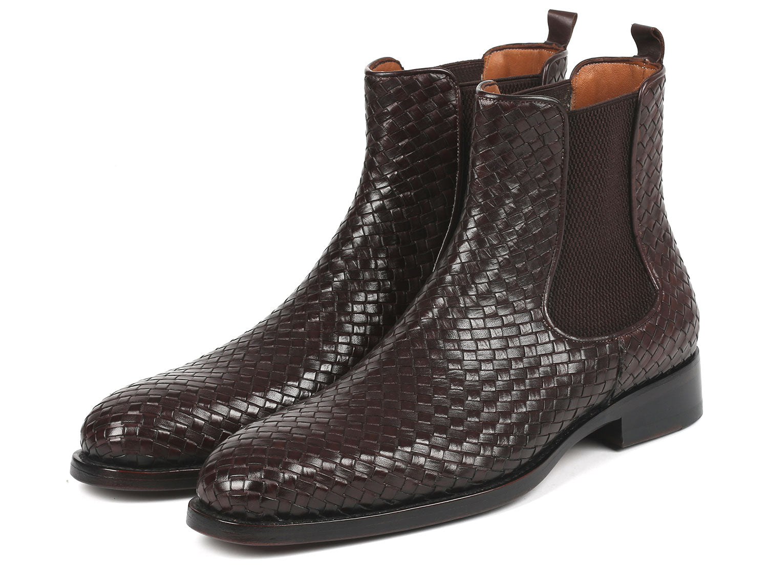 Pair of brown woven leather boots on a white background
