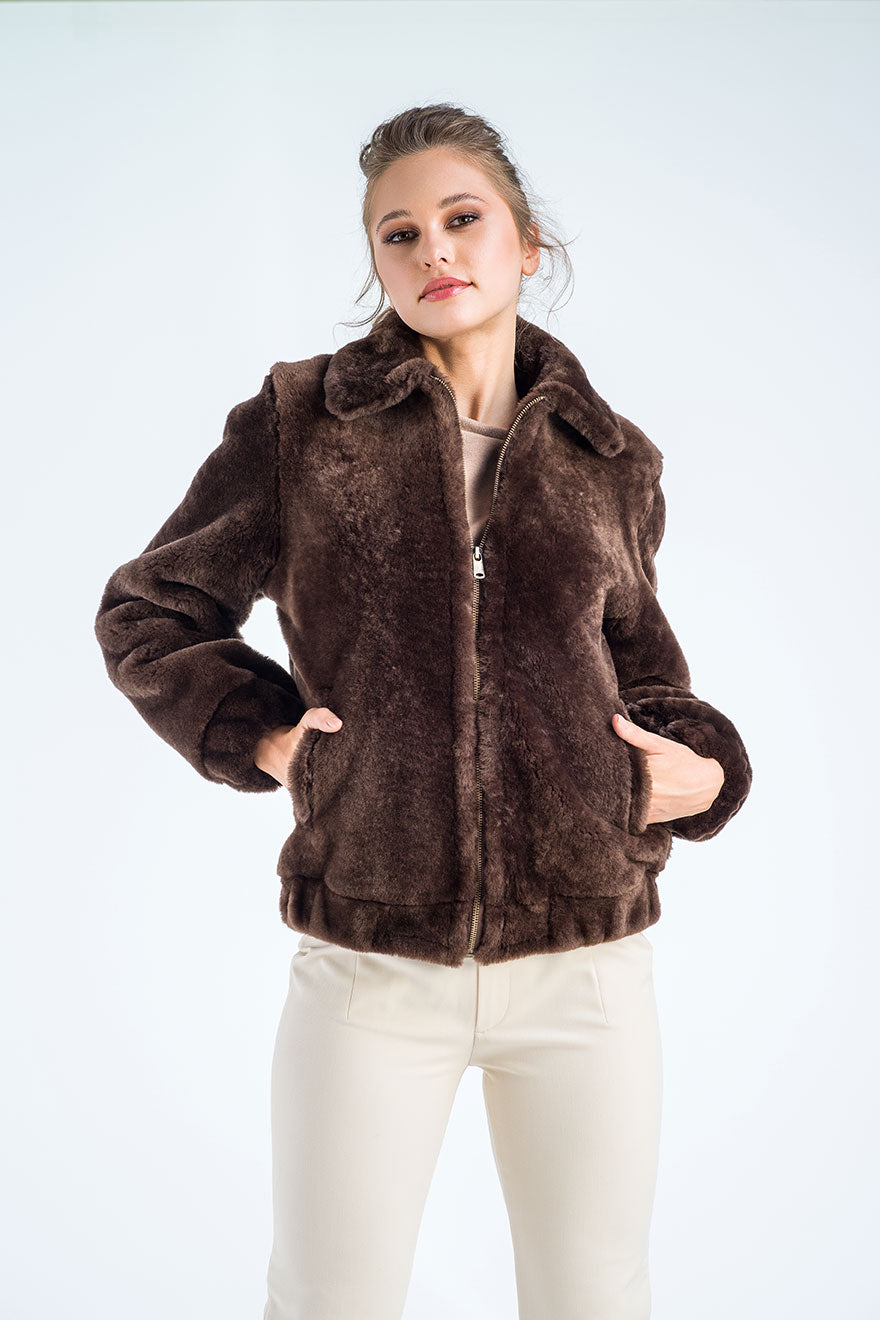 Woman wearing a brown fur jacket on a white background