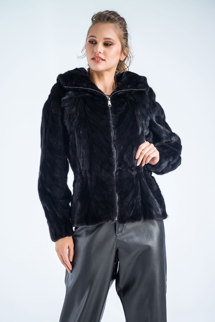 Woman wearing a black fur jacket on a white background