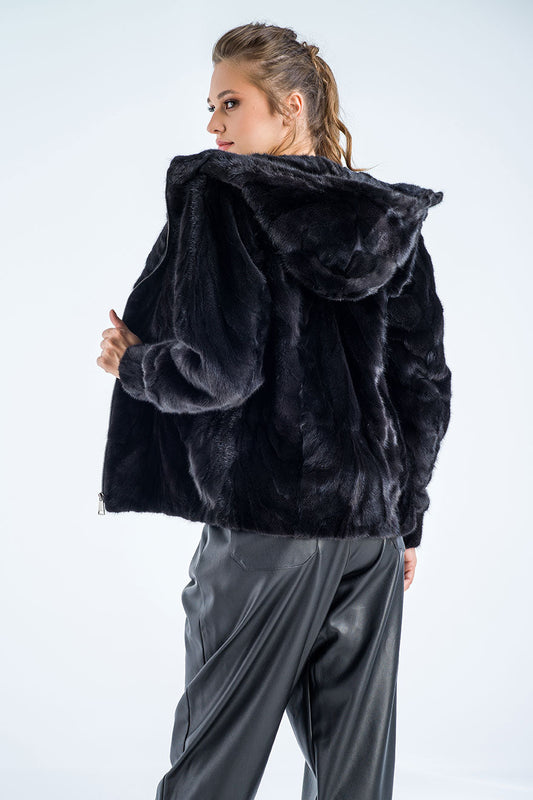 Person wearing a black fur jacket on a white background