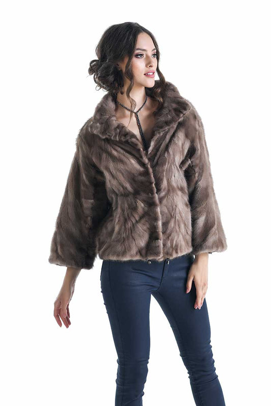 Woman wearing a brown fur coat on a white background