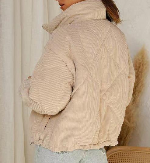 Beige corduroy jacket worn by a person against a neutral background