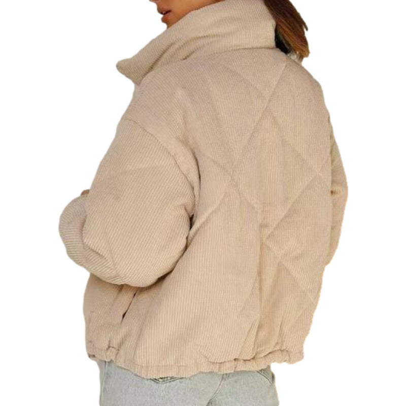 Beige quilted jacket worn by a person on a white background