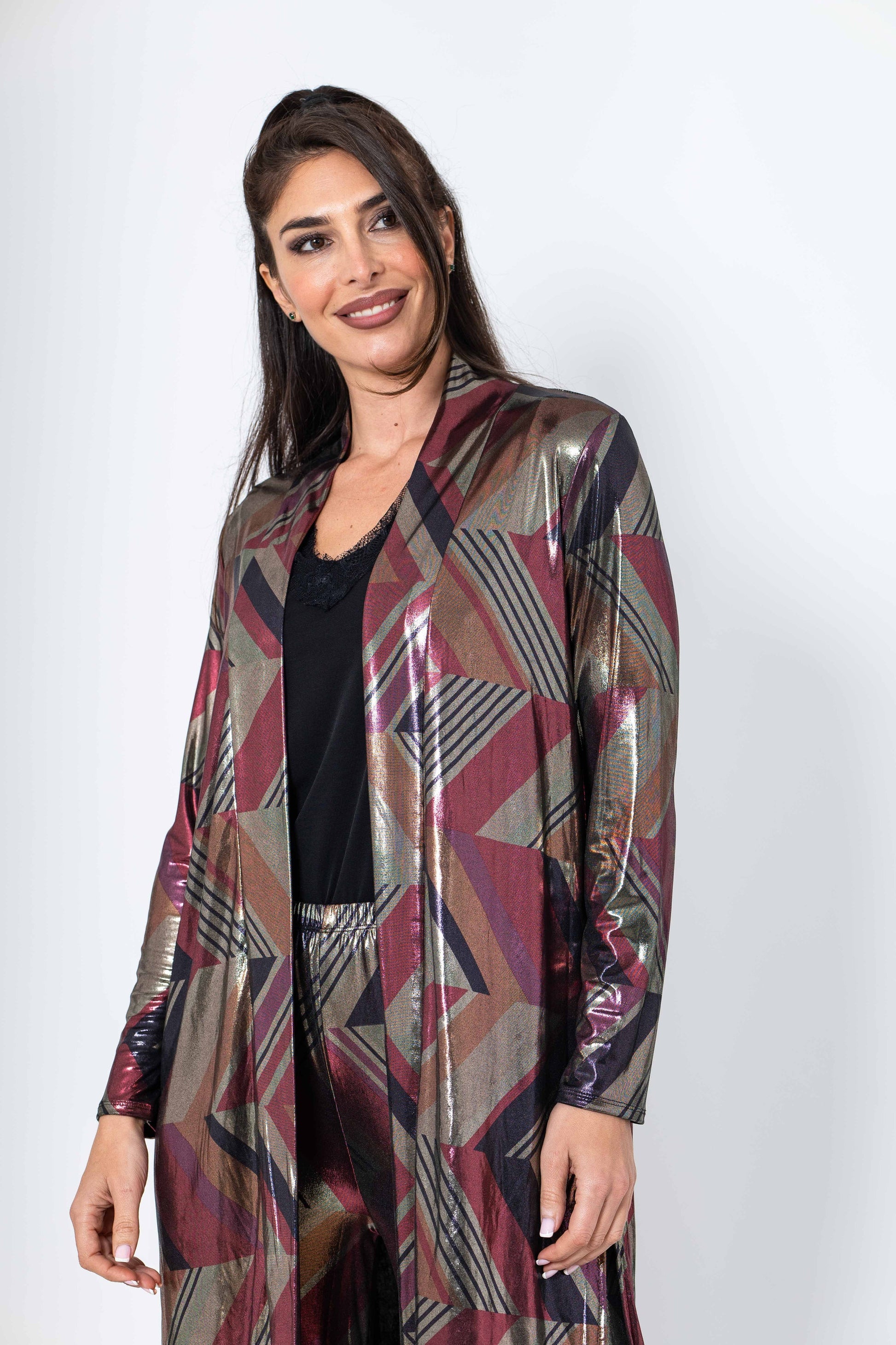 Woman wearing a patterned metallic jacket on a white background