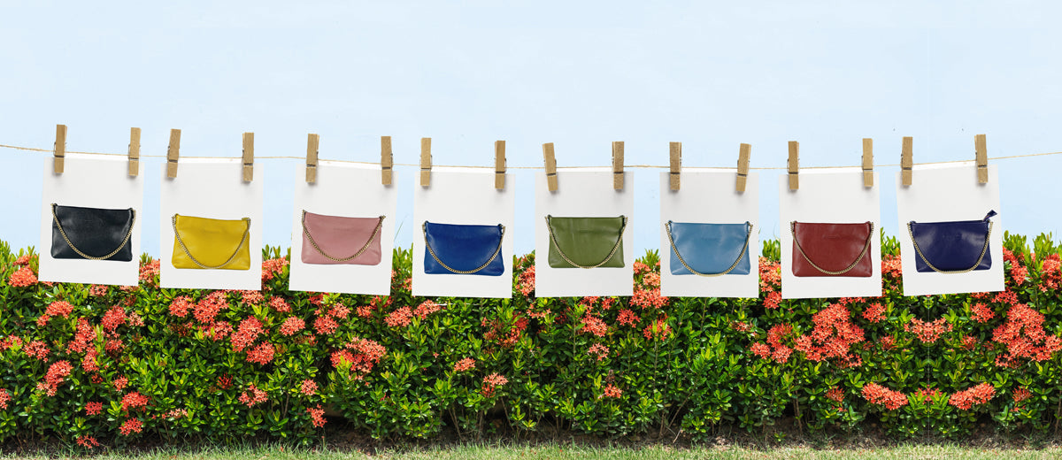 Colorful bags hanging on a clothesline with a floral background
