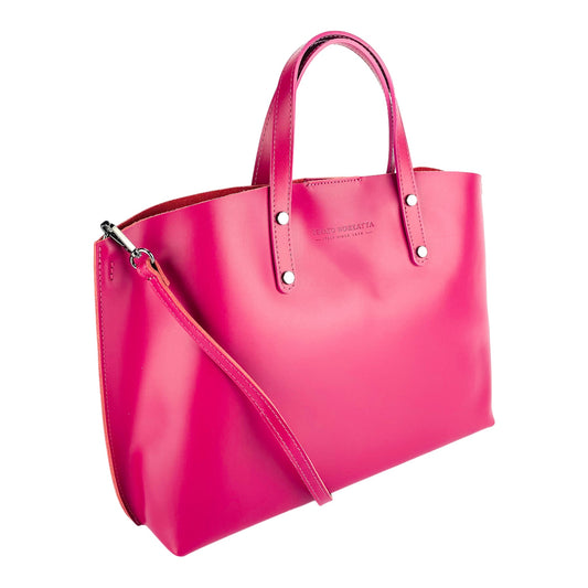 Pink handbag with a shoulder strap on a white background
